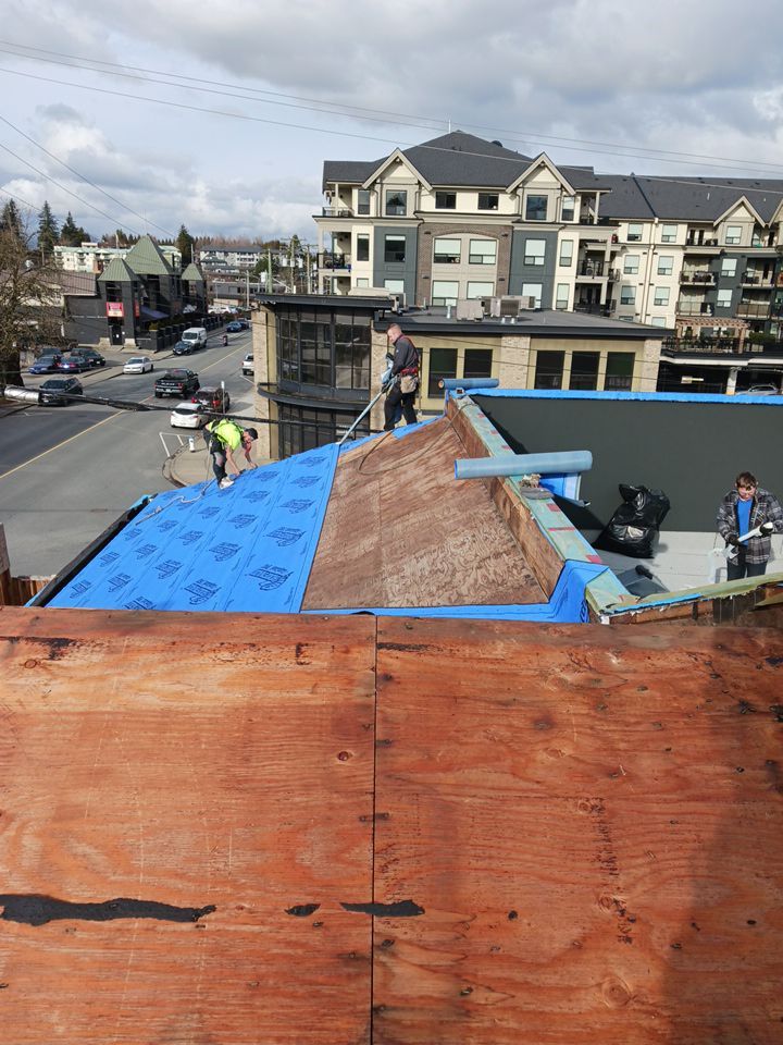 Commercial Roofing Installation using 12" Prolok metal and hidden gutters! by Top Notch Roofing Inc