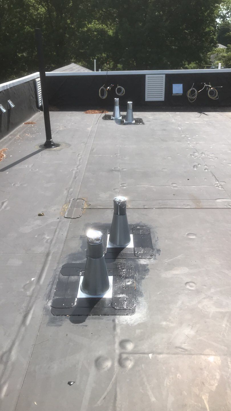 Commercial Roofing Installation using EPDM with white gutters by A Plus Exterior