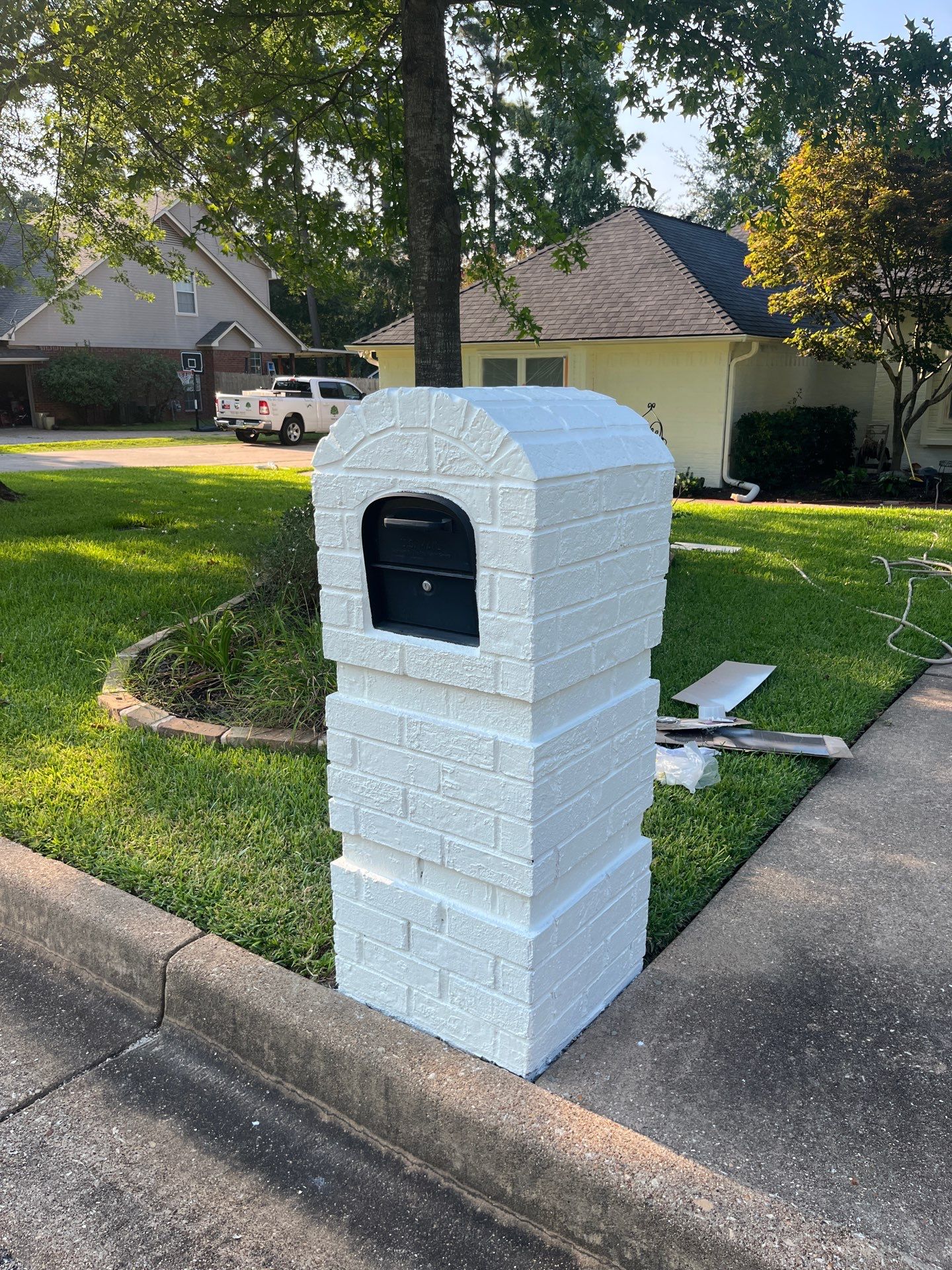 Exterior Painting in Tyler, TX | Brick House with White & Blue Finish by Quality Coats Painting