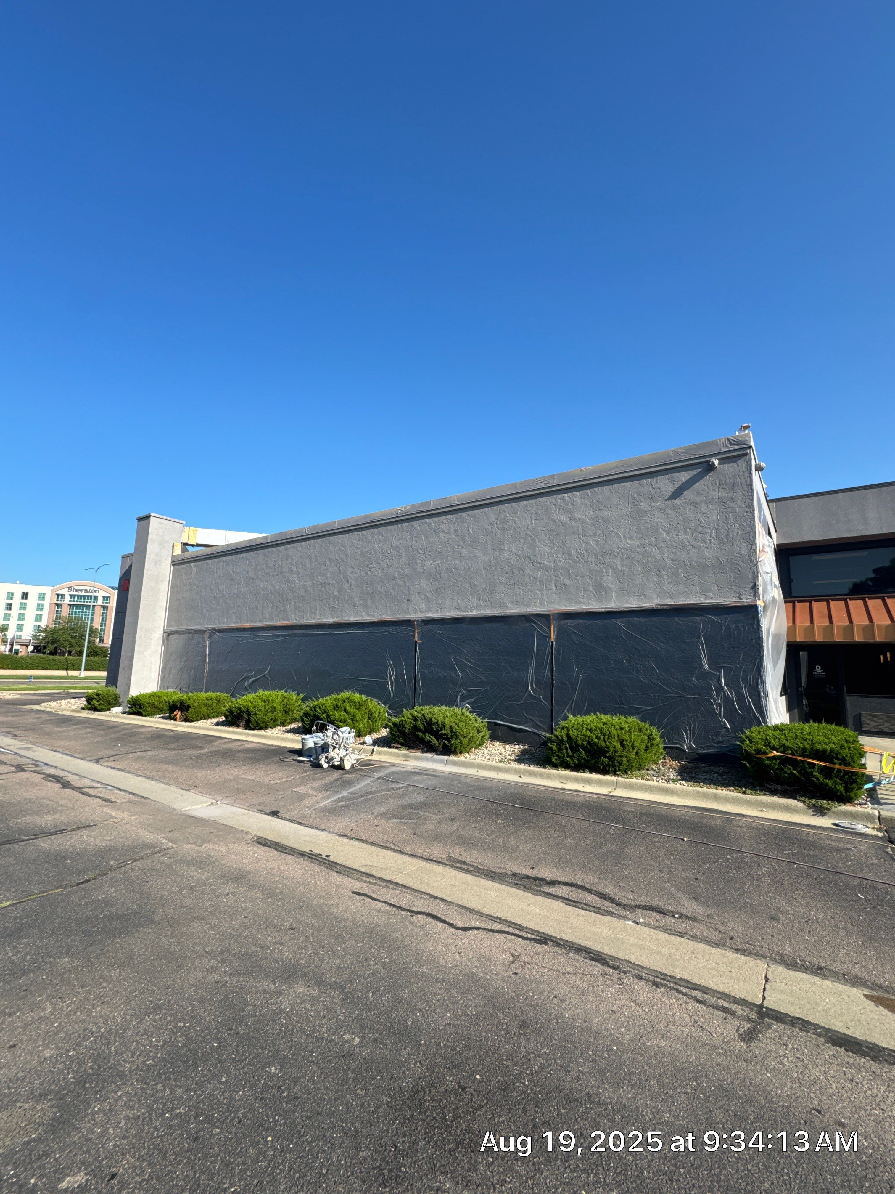 Commercial Exterior Painting with Stucco and Bold Red Accent Trim by Select Painting, Coatings & Garage Cabinets
