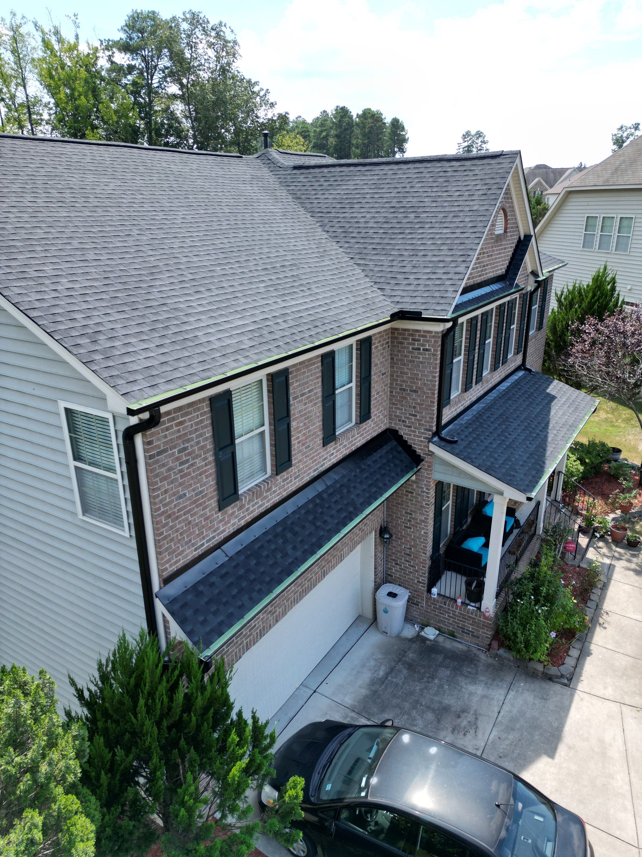 Roof Replacment - GAF Timberline HDZ Charcoal with 5” black seamless gutters  by Pro Performance Roofing