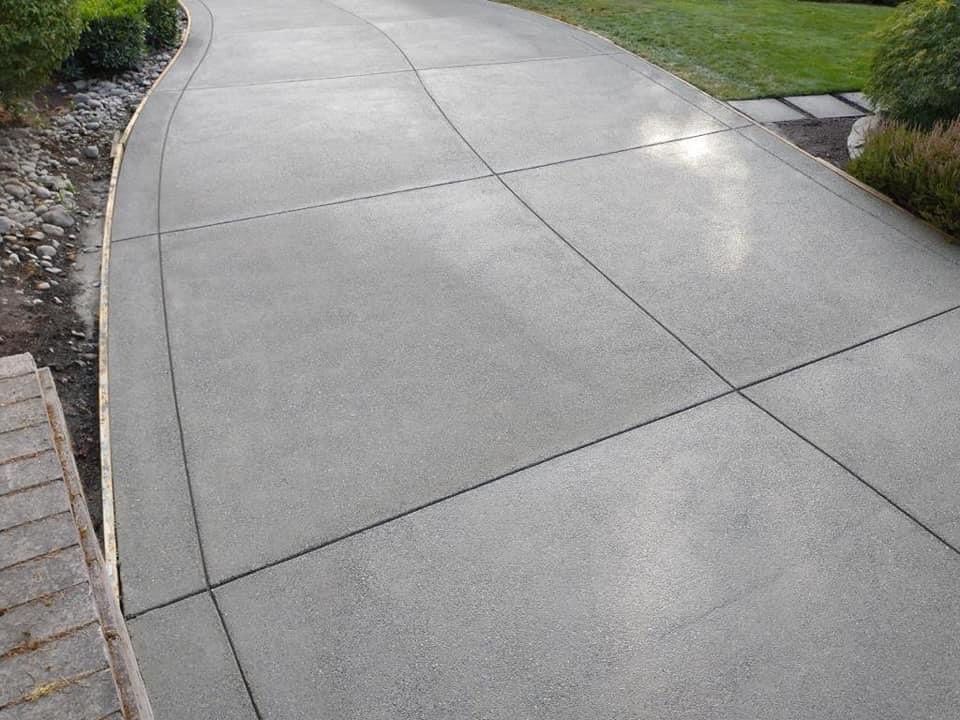 Cristi | Sand Finish Concrete Driveway  by Jireh Asphalt & Concrete Inc 