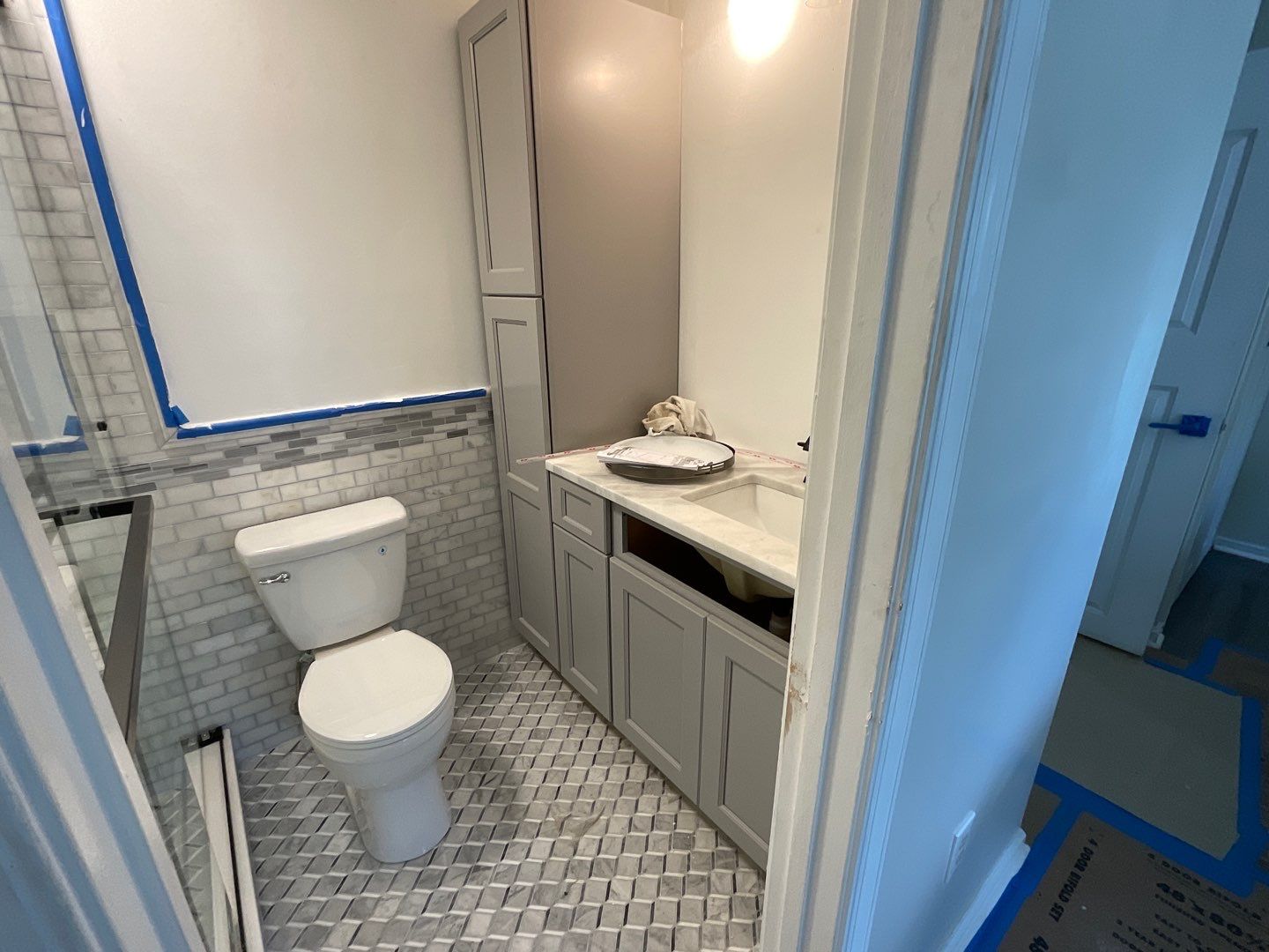 Bathroom Remodel using Two new bathroom design and new floors by Alpha Design Services