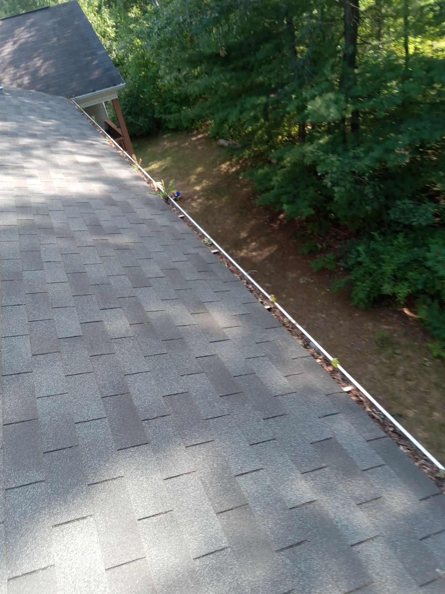 Commercial gutter cleaning Traverse City, MI before photo with filled gutters