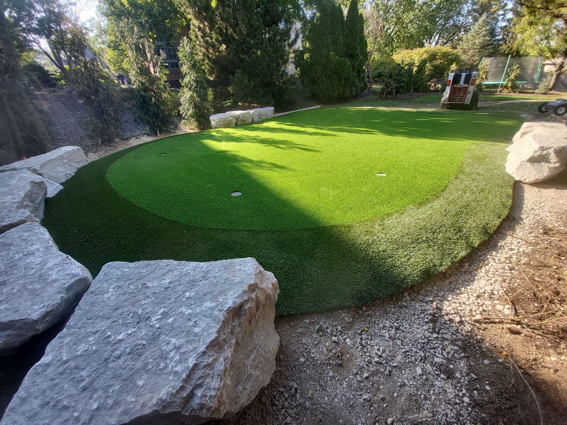 Custom Backyard Putting Green around Landscape Boulders in Hilliard by Southwest Greens Midwest