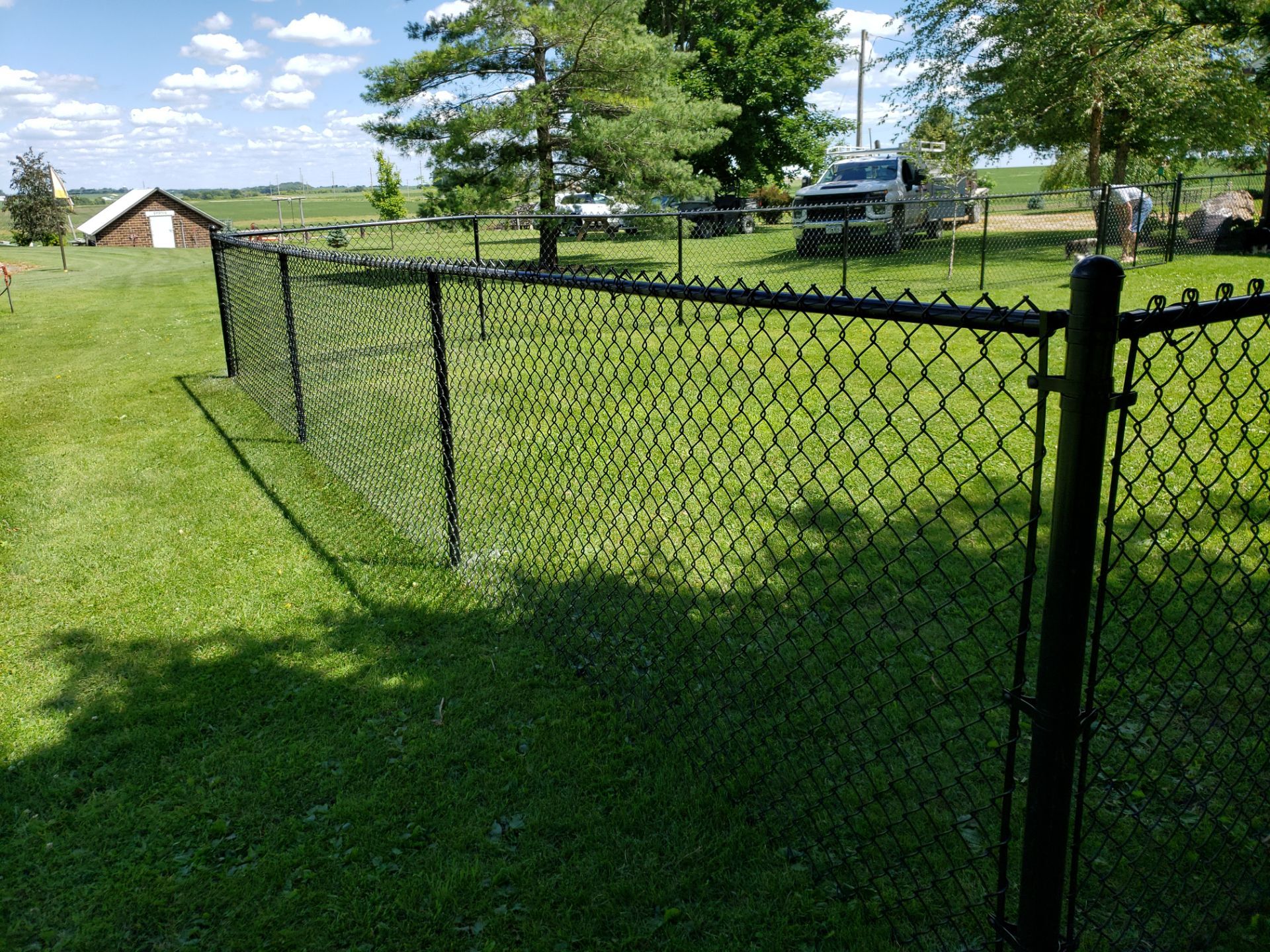 Residential Black Vinyl-Coated Chain Link Fence Installation in Bristow by Perfect Picket Fence and Stain