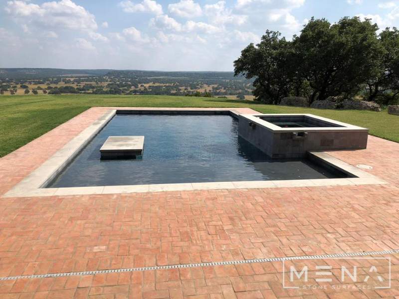 Kitchen, outdoor kitchen and pool brick floor installation by Mena stone surfaces