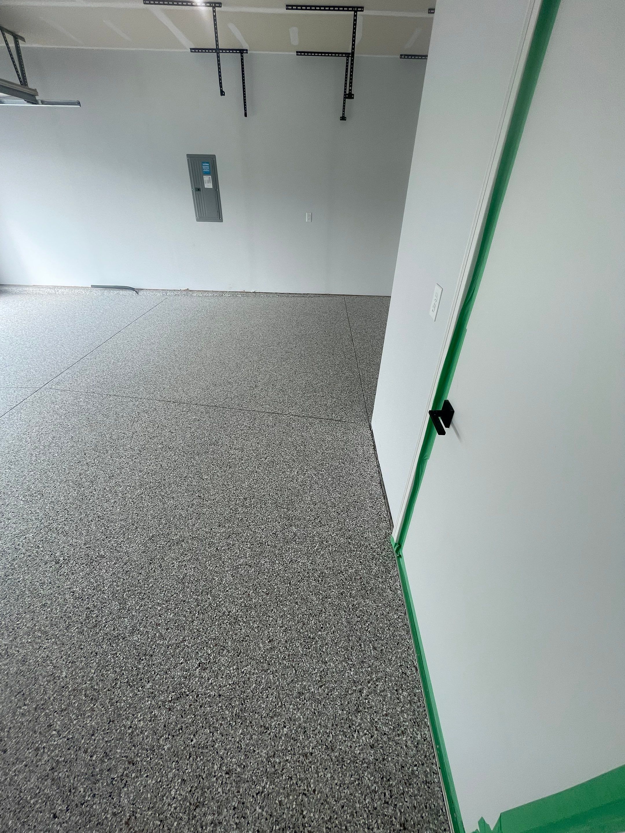 Custom Coyote Flake Garage Floor Coating in Sioux Falls by Select Painting, Coatings & Garage Cabinets