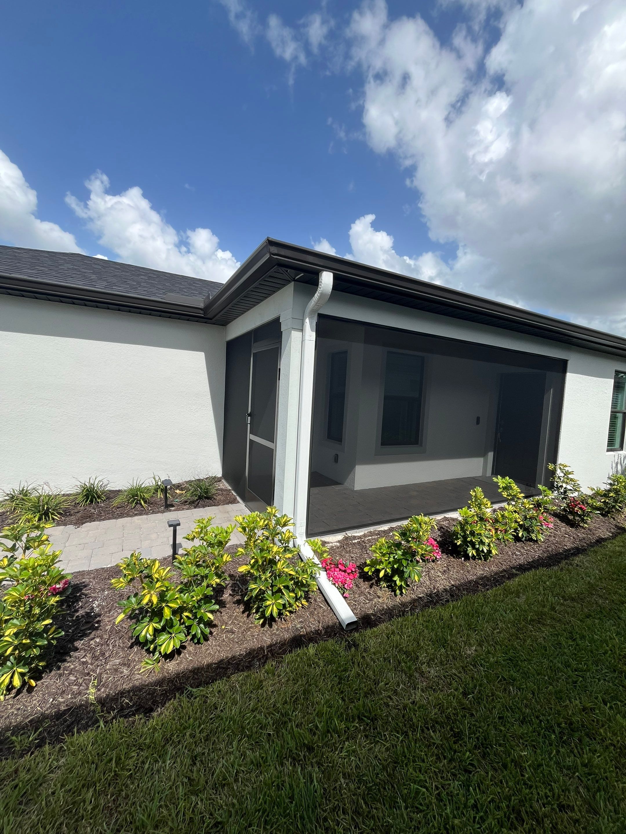 Dark Bronze Gutters and White Downspouts in Sarasota FL by Gutter Professors