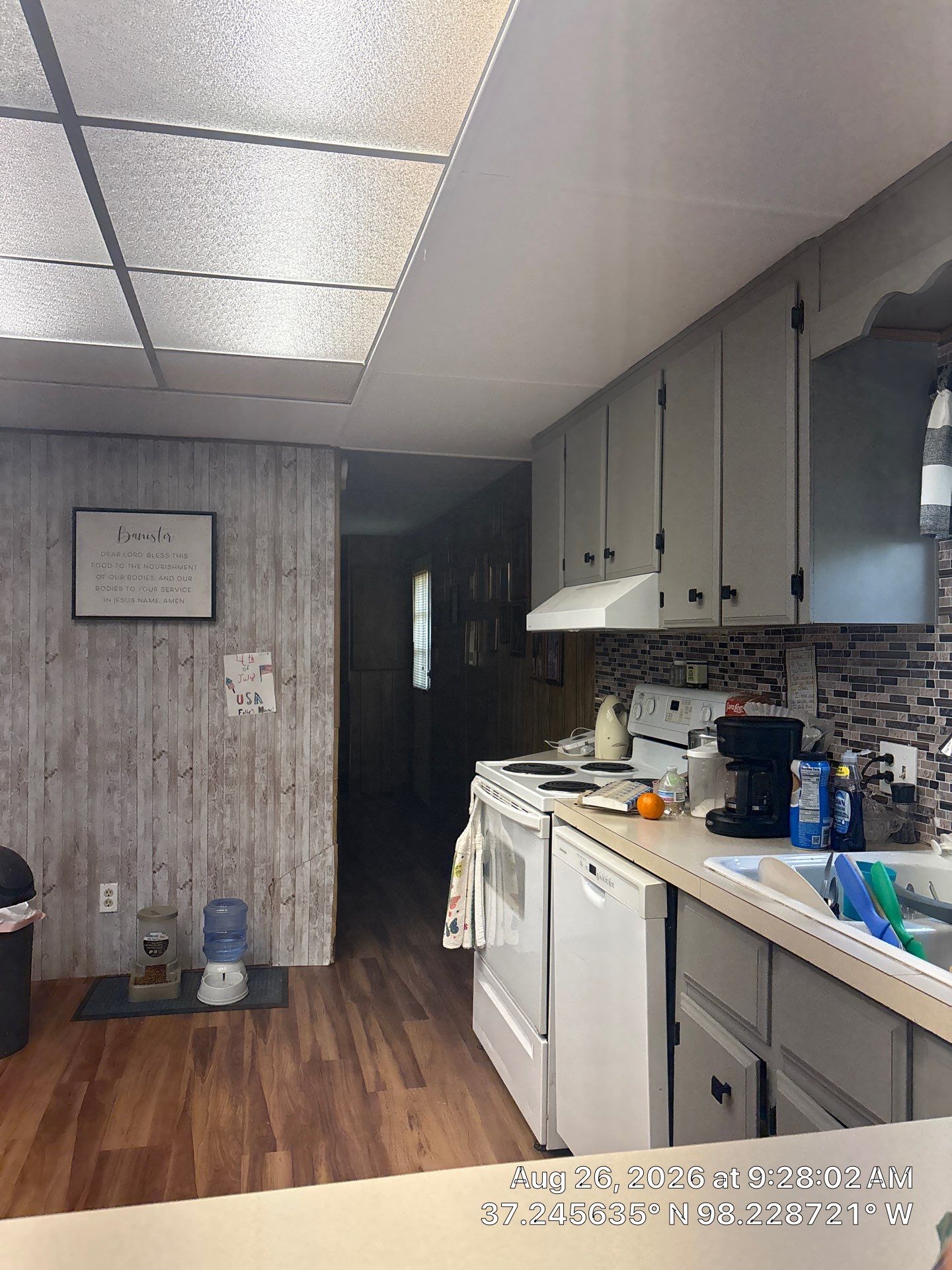 Modernized Kitchen with Gray Painted Cabinets and Tile Backsplash by CompanyCam Sales Demo