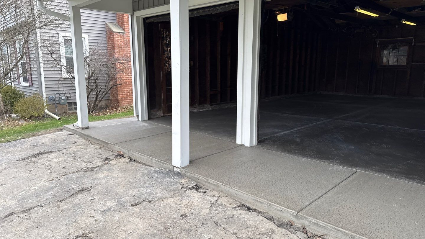 Concrete garage floor replacement with a broom finished apron and sidewalk by NG Masonry & Construction LLC