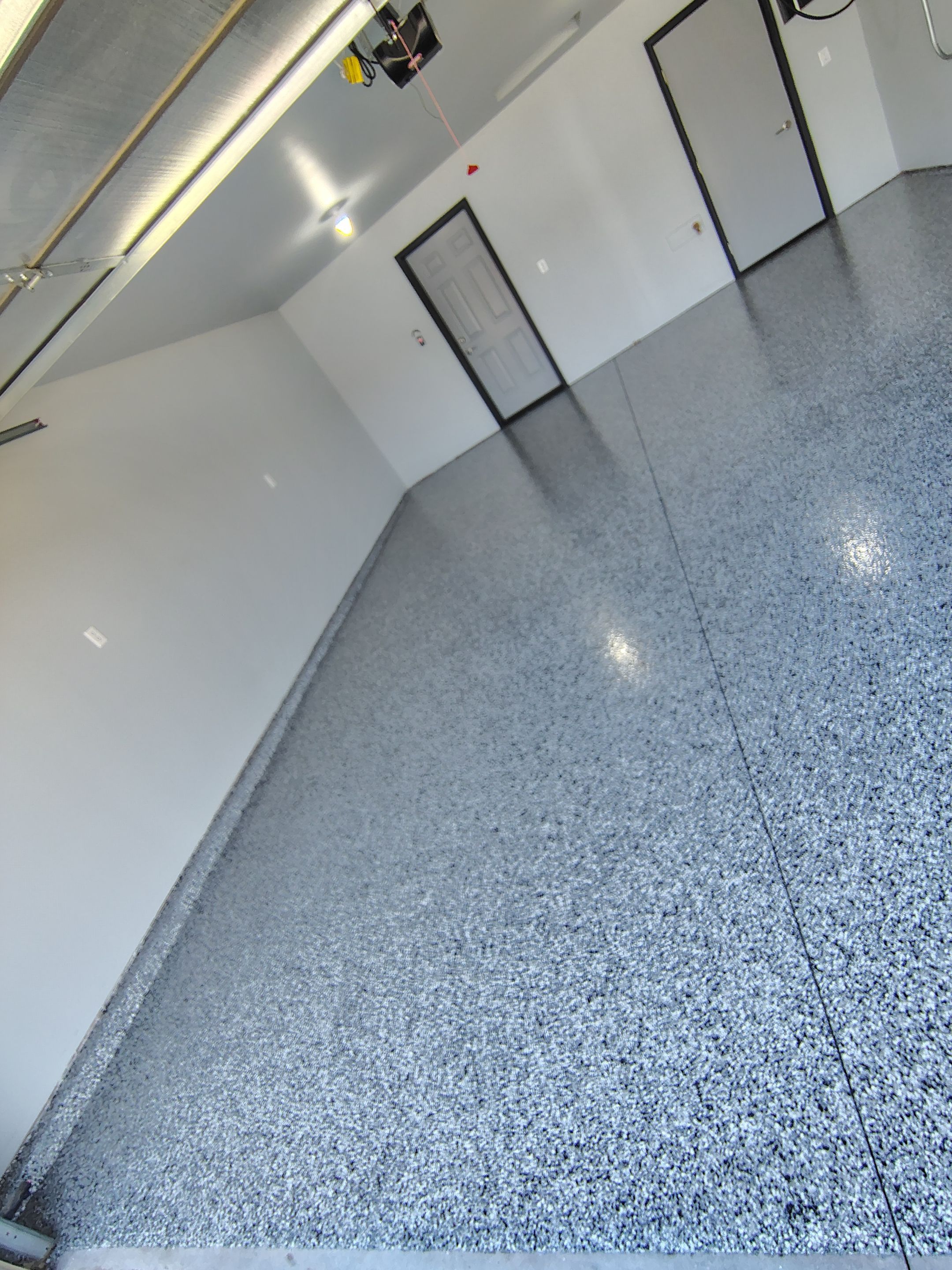 Custom Epoxy Garage Floor Coating Installation in Sioux Falls by Select Painting, Coatings & Garage Cabinets