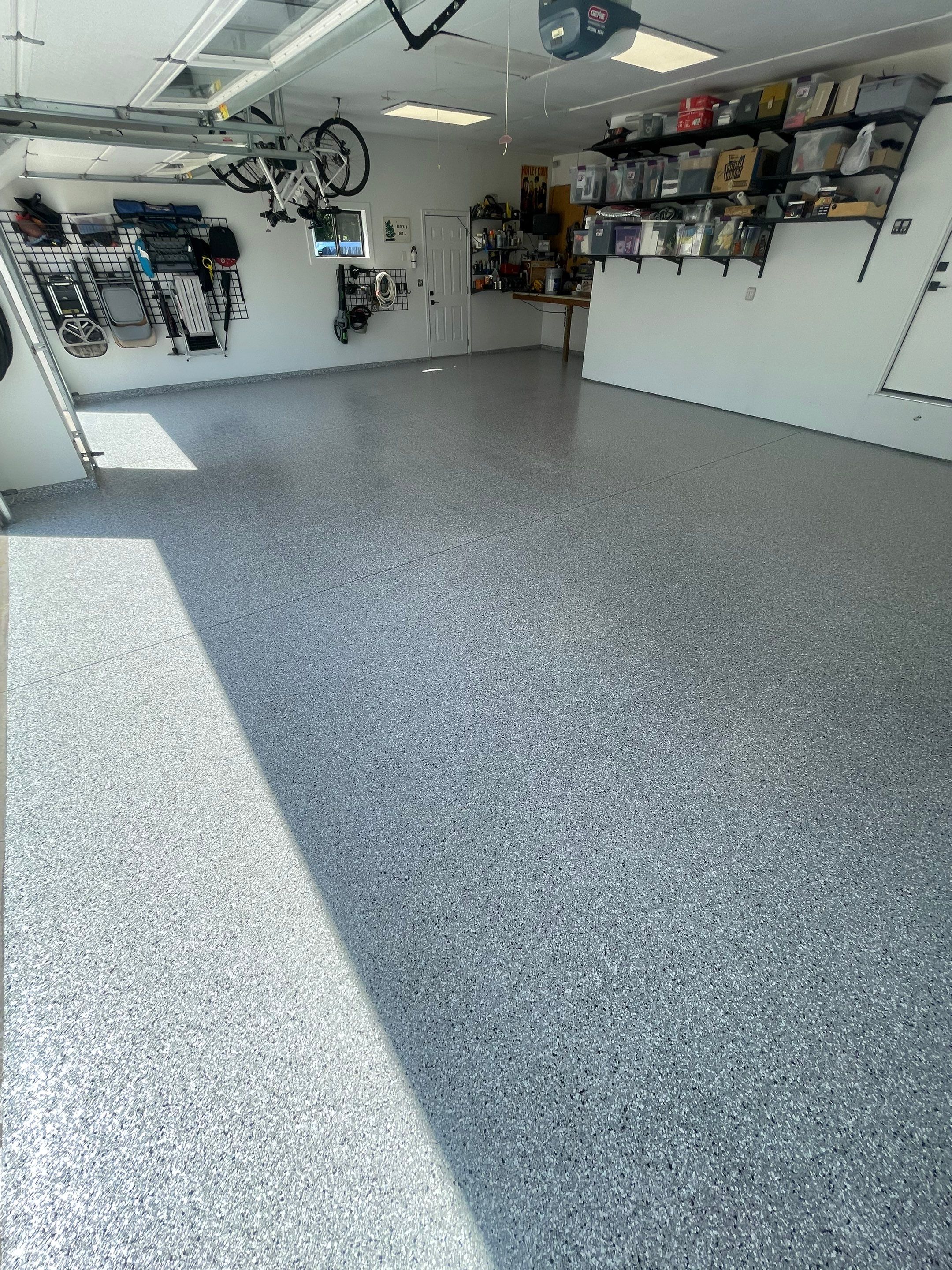 Feather Grey Garage Floor Coating Installation in Sioux Falls by Select Painting, Coatings & Garage Cabinets