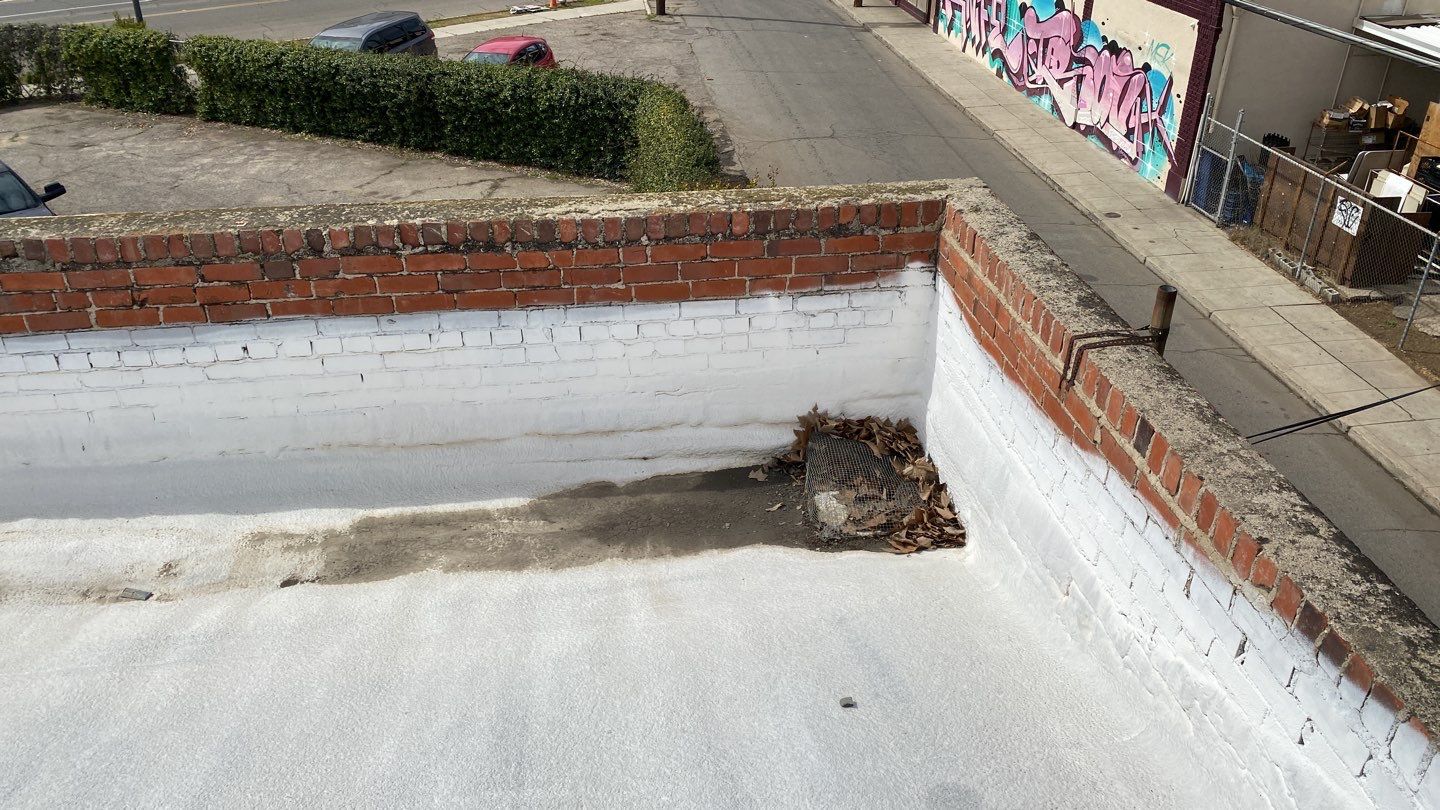 Polyurethane foam roof refurbish and recoating by Straight Edge Roofing Inc