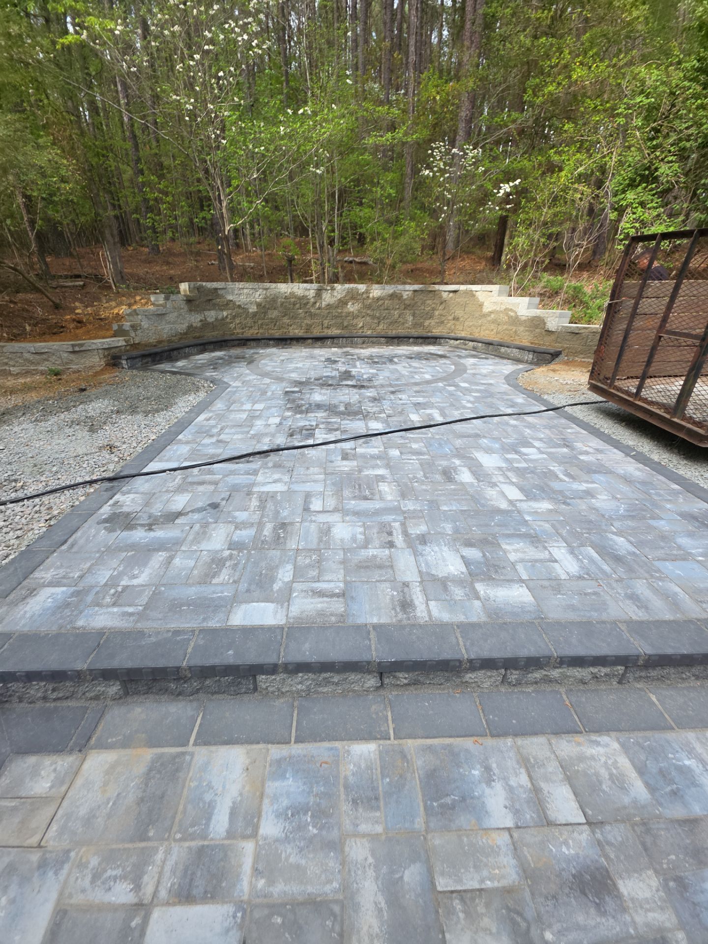 Pittsboro Outdoor Living Transformation – Retaining Wall, Paver Patio & Elevated Deck by Elite Remodeling and Design LLC
