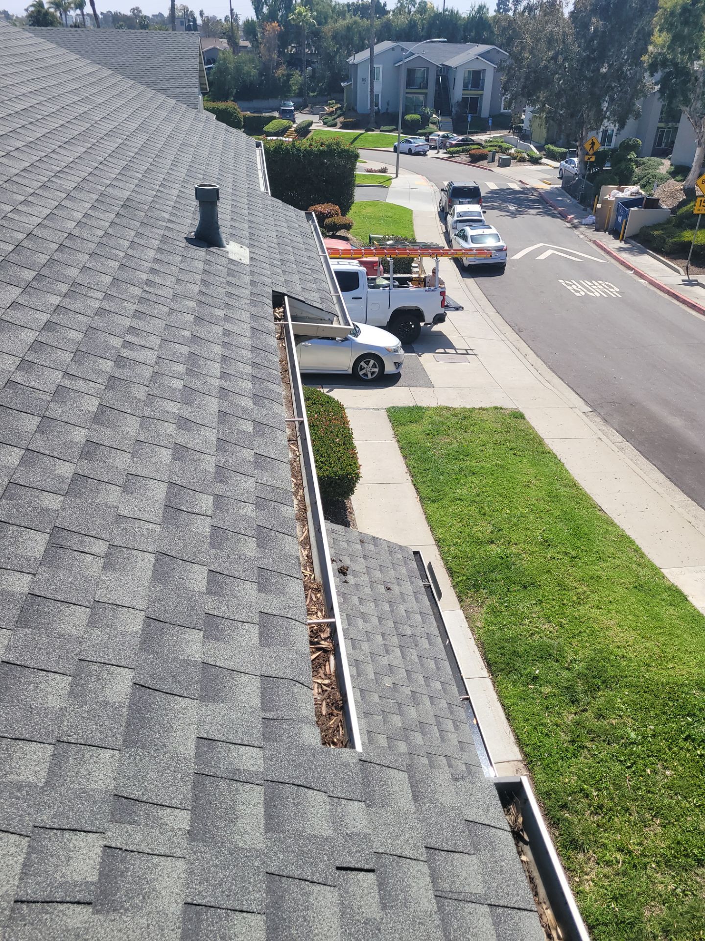 Commercial gutter cleaning San Diego before photo with filled gutters