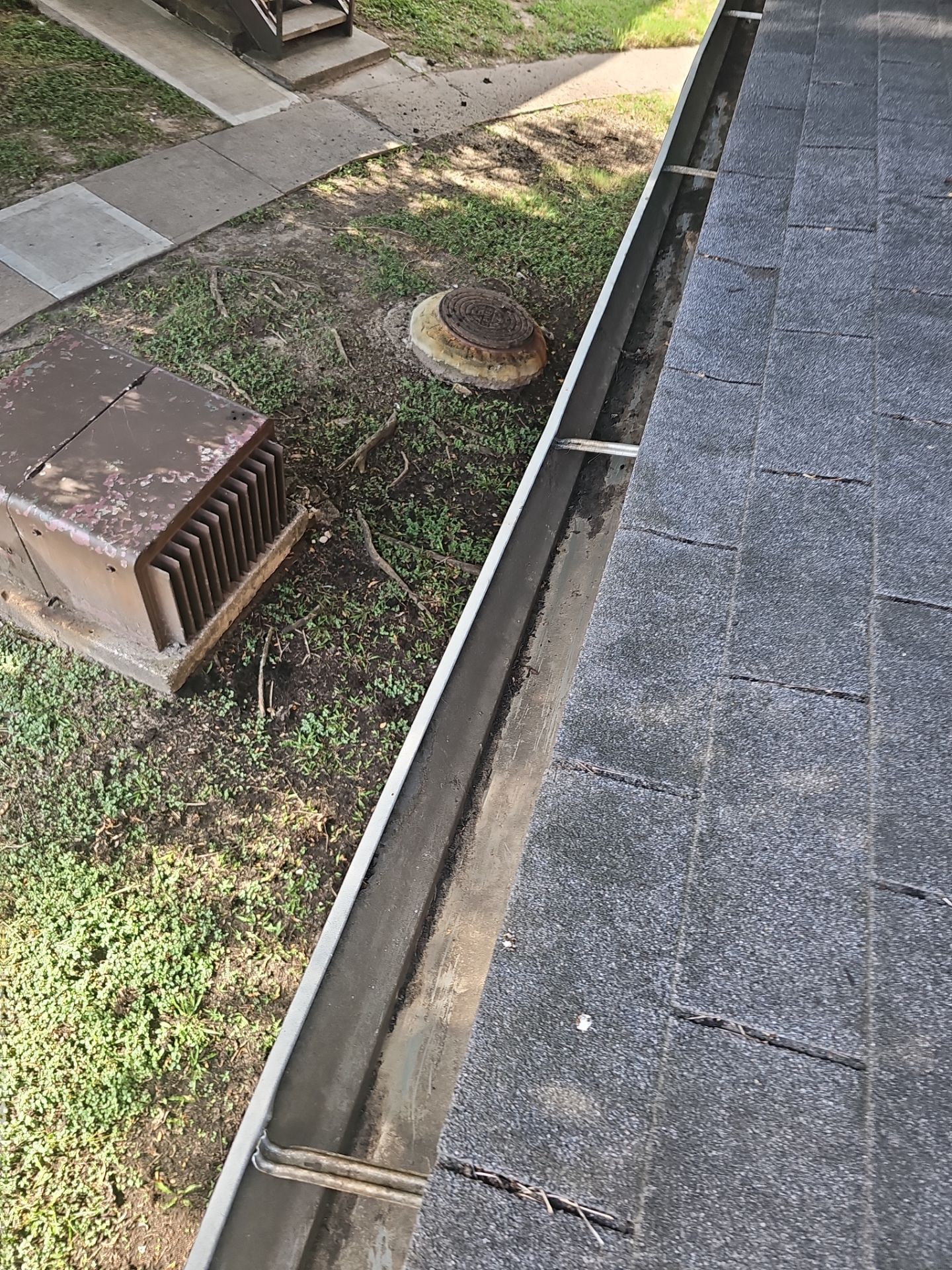 HOA gutter cleaning in League City & Webster, after  photo showing full gutters.