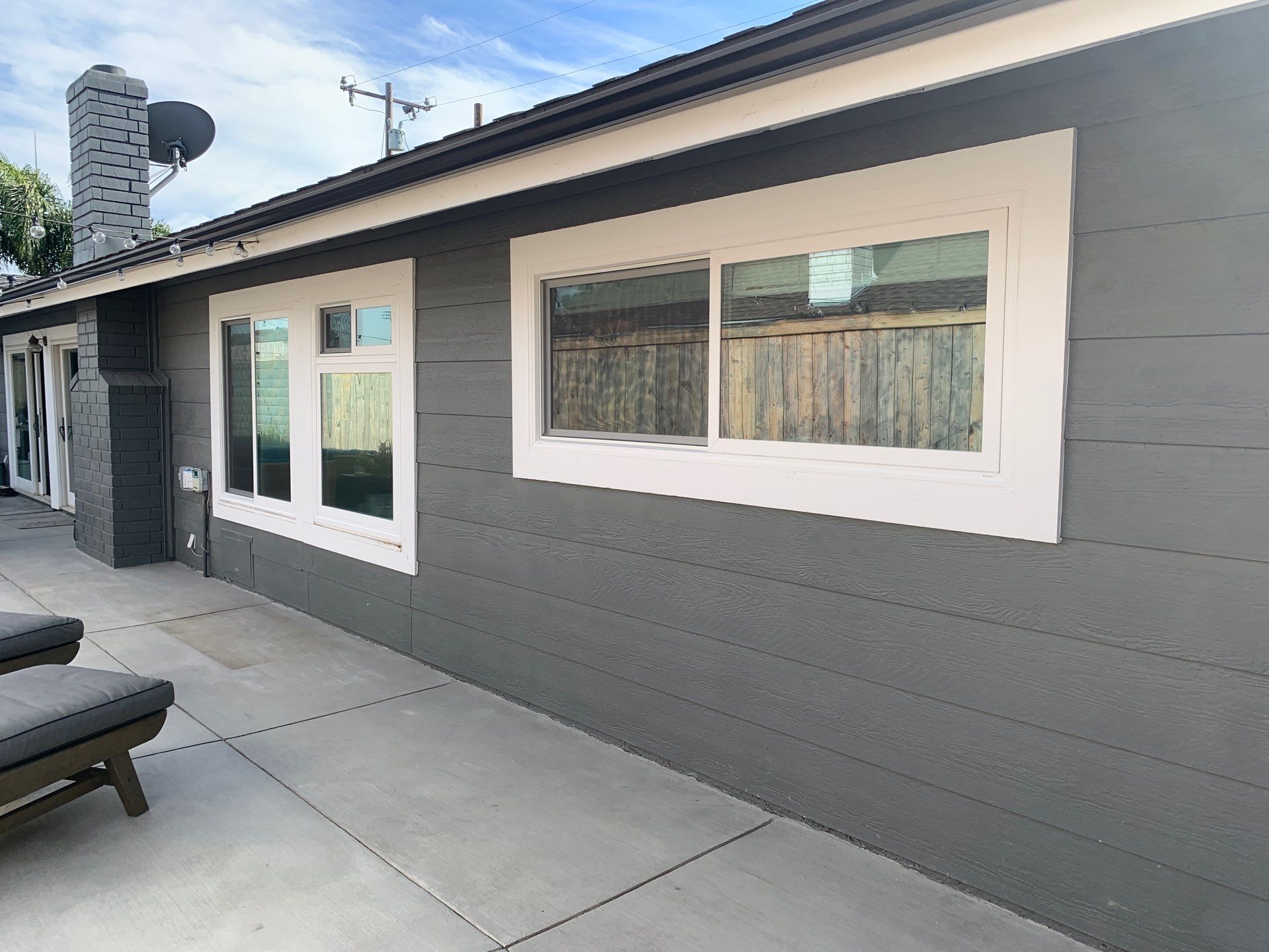 Window Installation using Milgard black vinyl windows by American Window Company