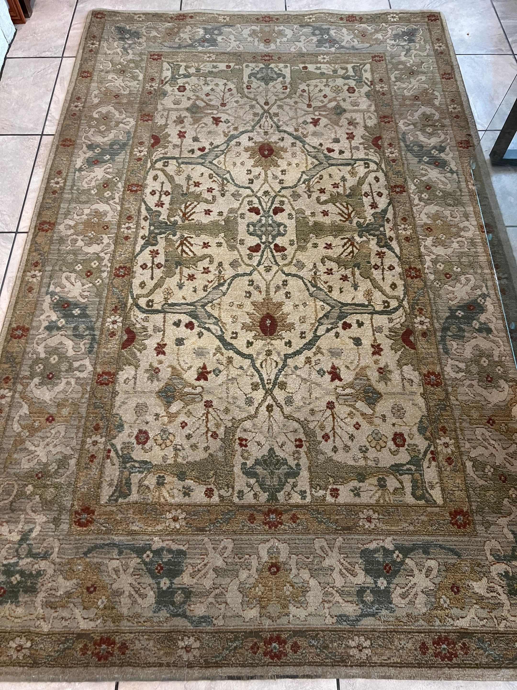 the service being done is deep cleaning of a large area rug on a tile floor