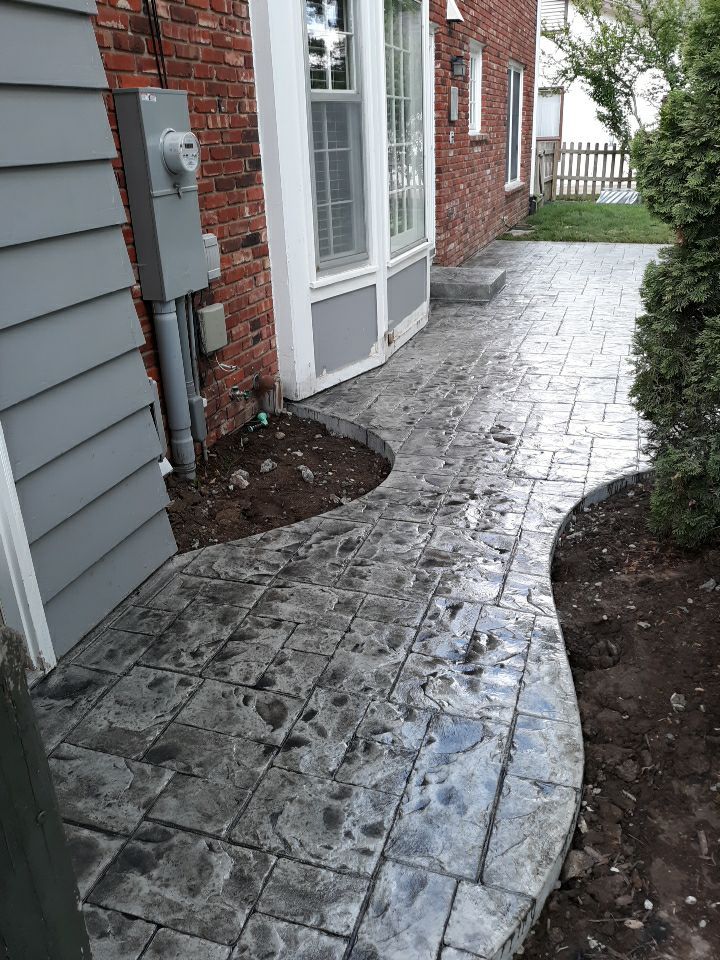 Back Yard Stamped Patio by LAND ESCAPES LLC