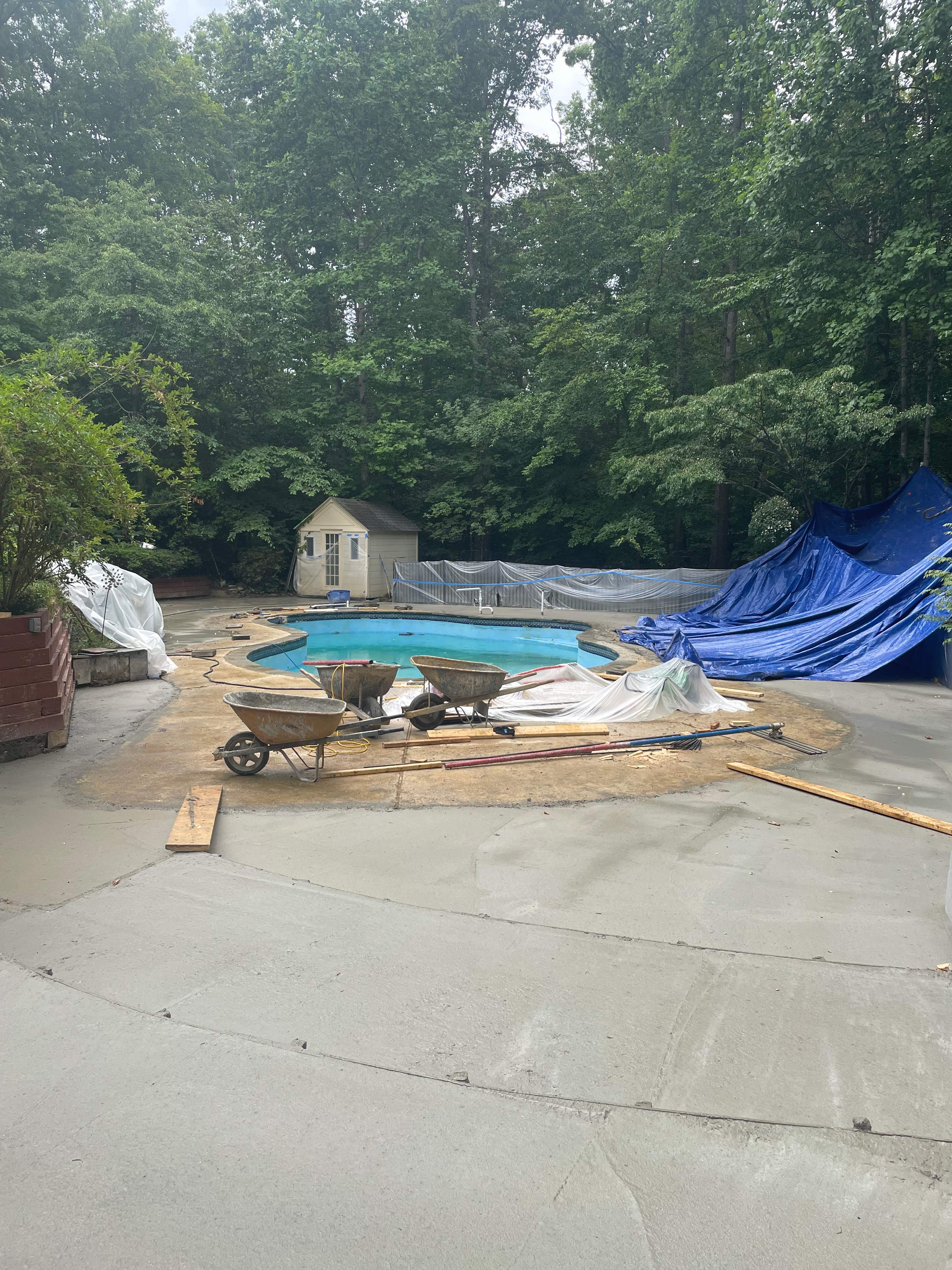 Pool Surround remodel with retaining walls, new waterfall and water slide by Fairfax Contractors, LLC