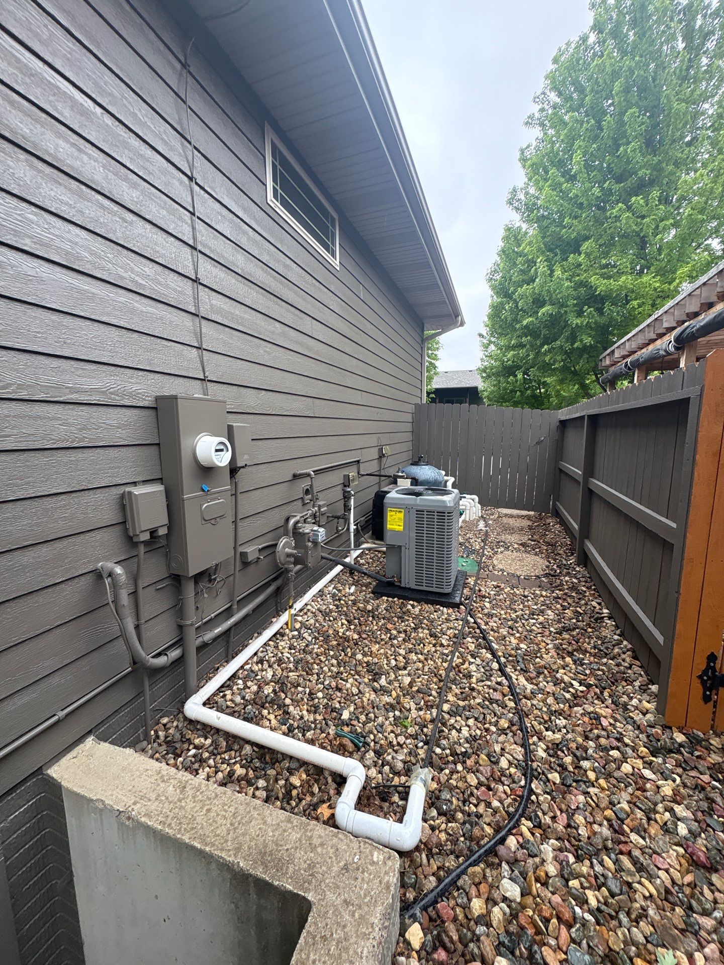 Sioux Falls Residential Exterior Update and Flagstone Pool Deck by Select Painting, Coatings & Garage Cabinets