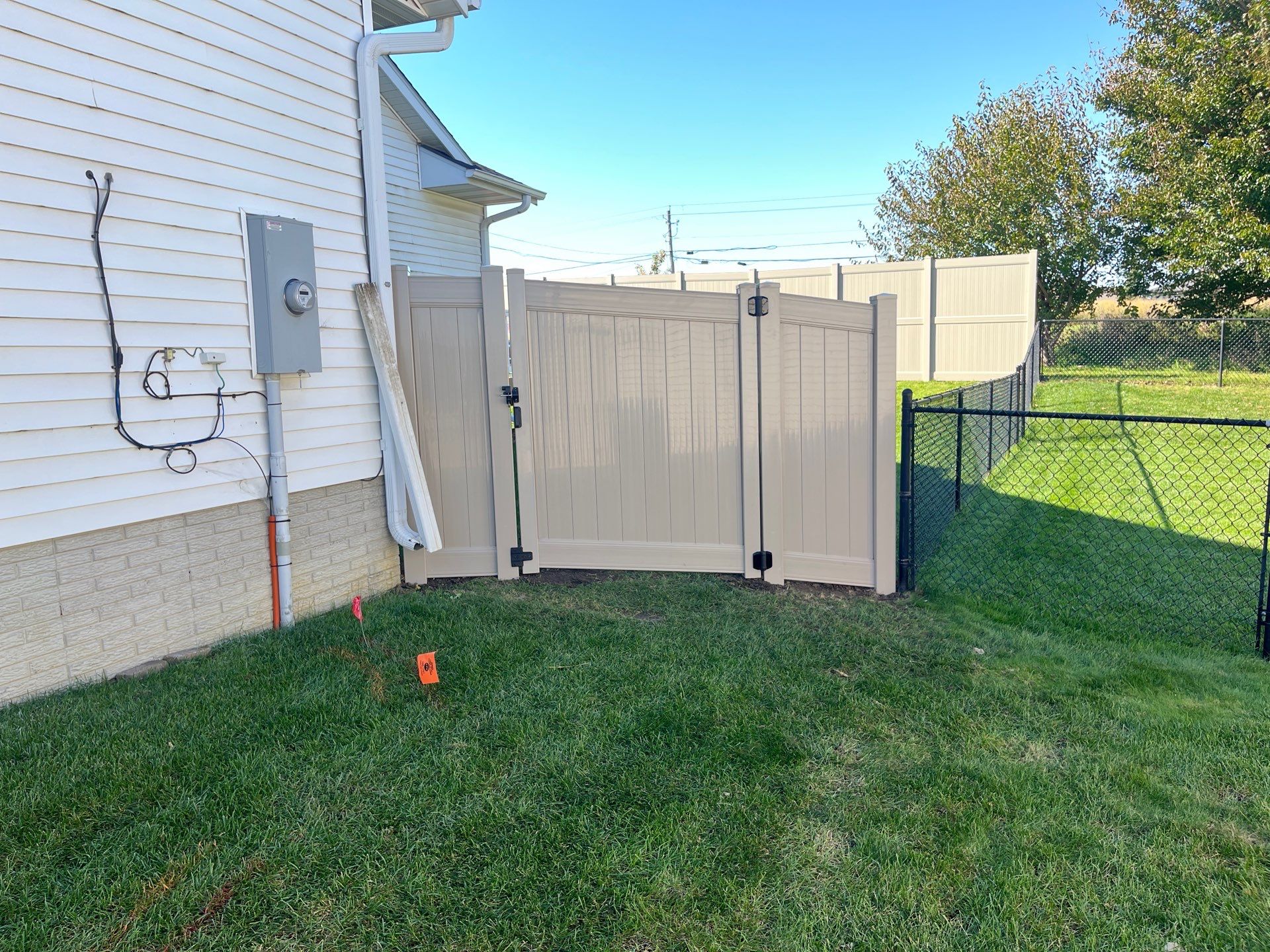 Adobe Vinyl Privacy Fence and Gate Installation in Cedar Falls by Perfect Picket Fence and Stain