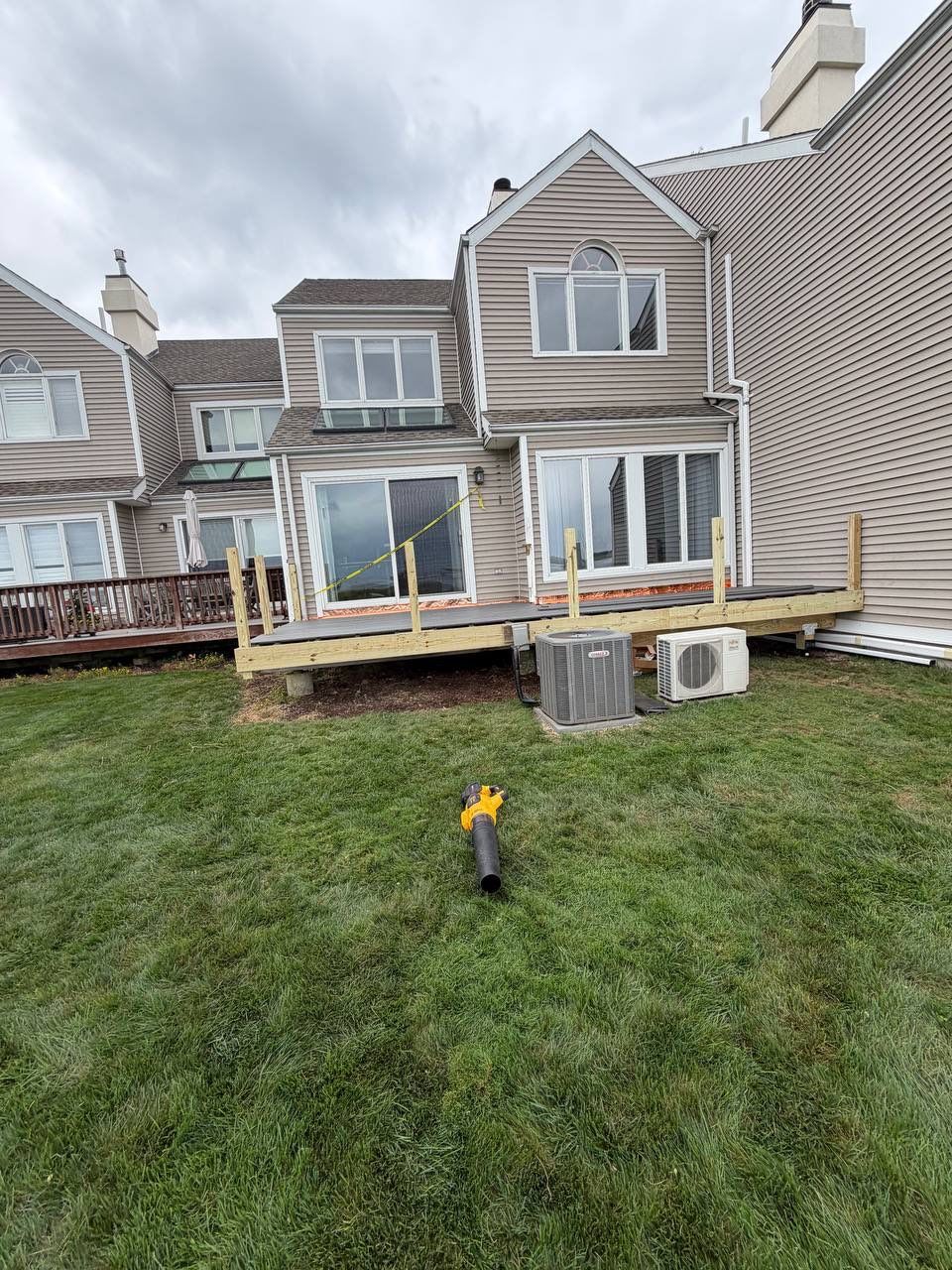 Deck replacement using trex Tropical Island mist and Pressure treated railings. by DiGiorgi Roofing and Siding Inc