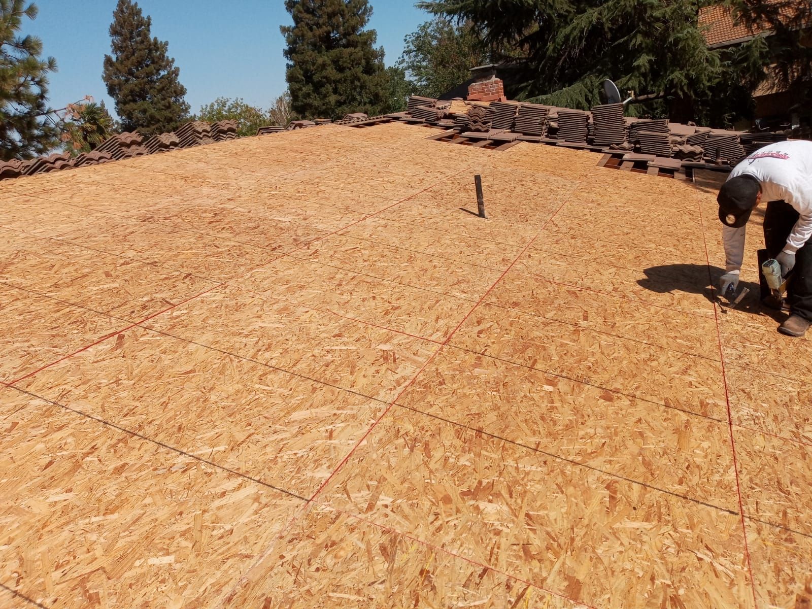 Tile roof remodel/ install OSB sheathing under tile and replace using OSB board with new underlayment, tile, and battens by Straight Edge Roofing Inc