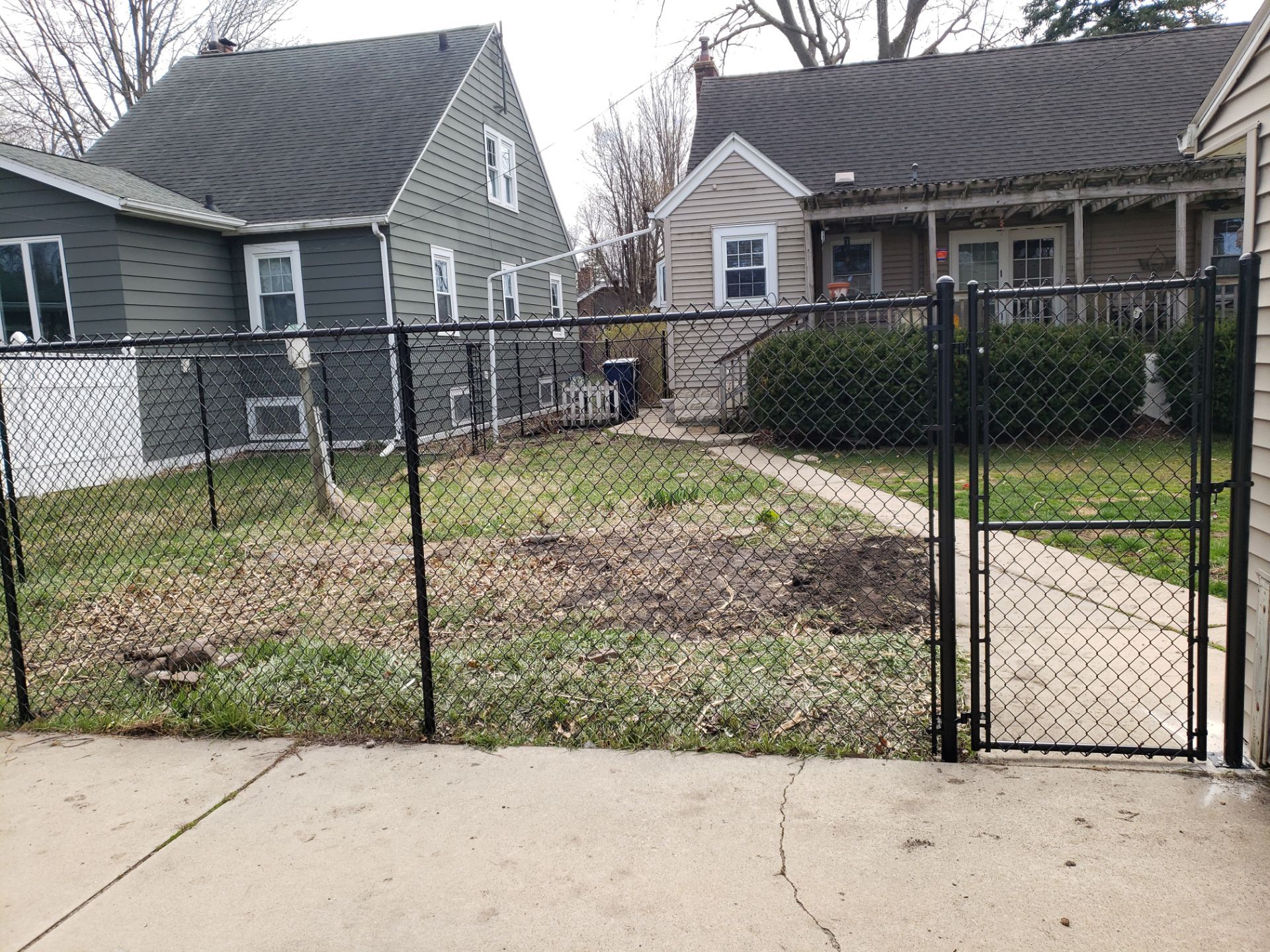 Black Vinyl Coated Chain Link Fence Installation in Waterloo by Perfect Picket Fence and Stain