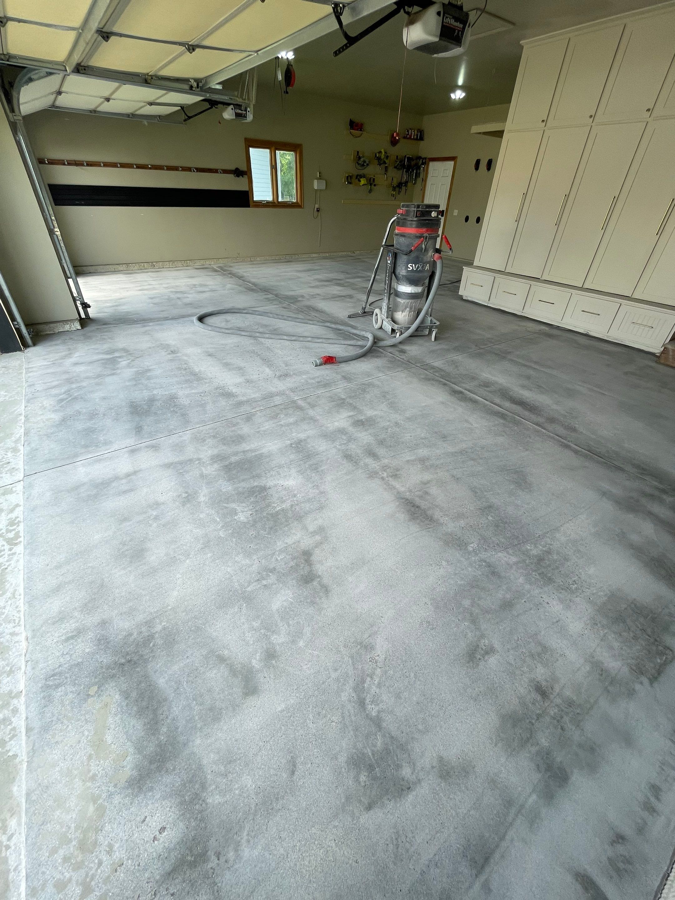 Cabin FEver Flake Garage Floor Coating Installation in Sioux Falls by Select Painting, Coatings & Garage Cabinets