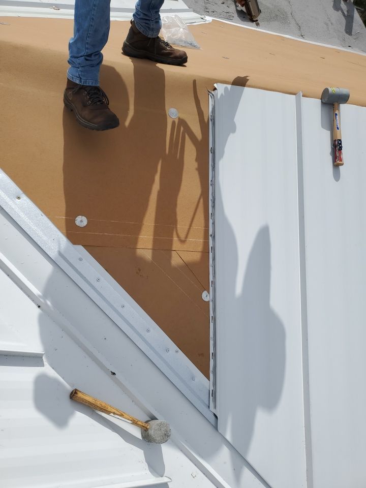 Residential Roofing Installation using 1.5" Nail Strip 24ga Solar White Kynar Coated Standing Seam Metal Panels by Morton Roofing, Inc.