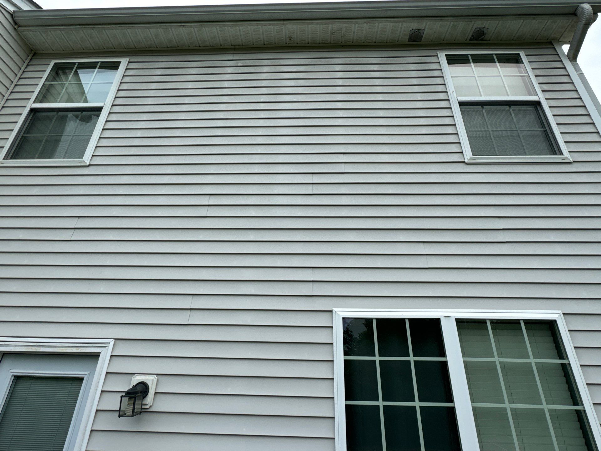 pressure washing exterior siding and windows removing dirt grime molds for home maintenance and curb appeal