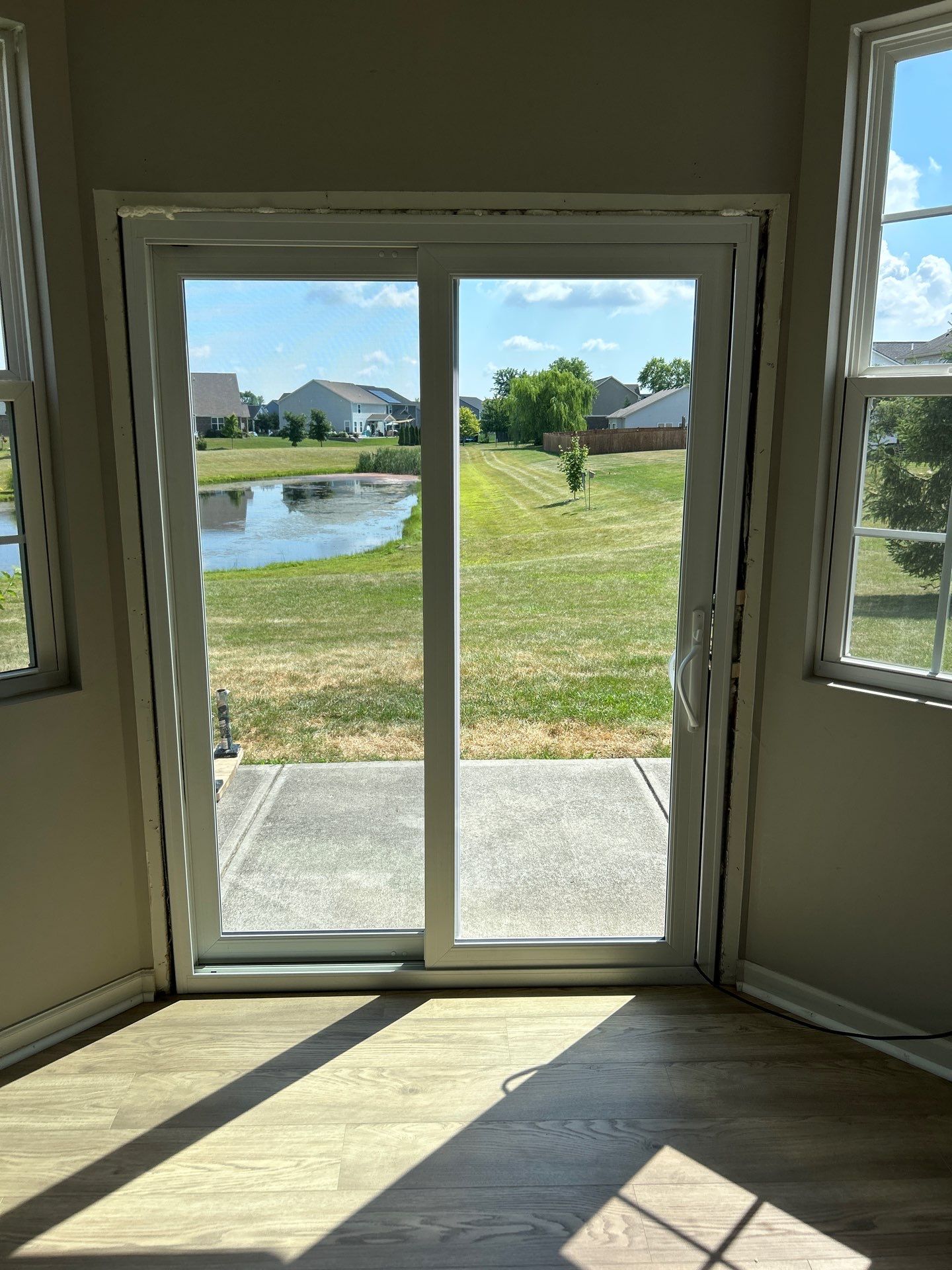 White Vinyl Sliding Patio Door Replacement in McCordsville by Merrifield Exteriors, LLC
