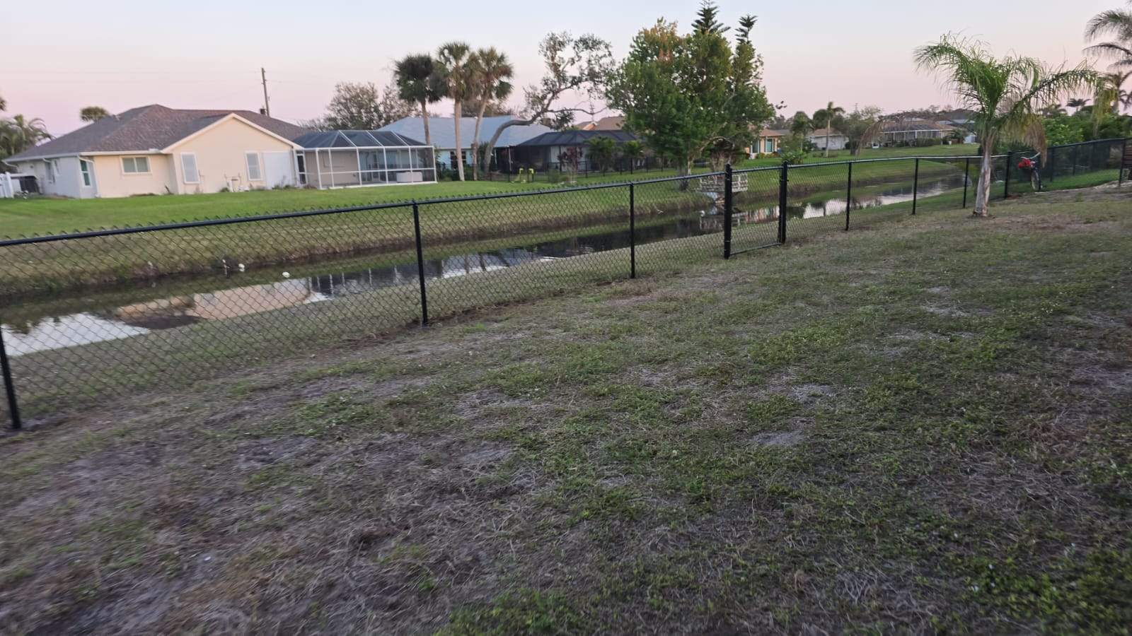 Waterfront Black Chain Link Fence Installation in Rotonda West by True Fence LLC