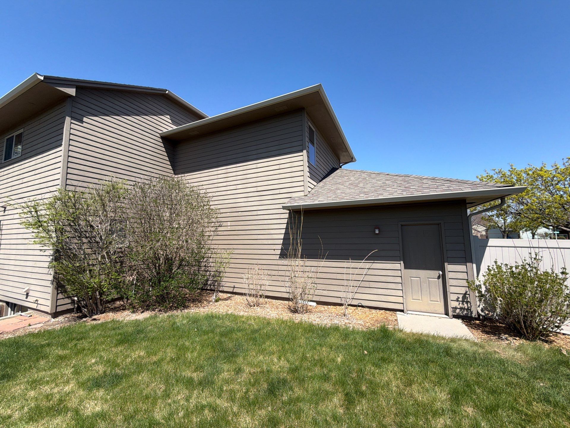 Residential Exterior Painting with Shutter and Trim Updates in Sioux Falls by Select Painting, Coatings & Garage Cabinets