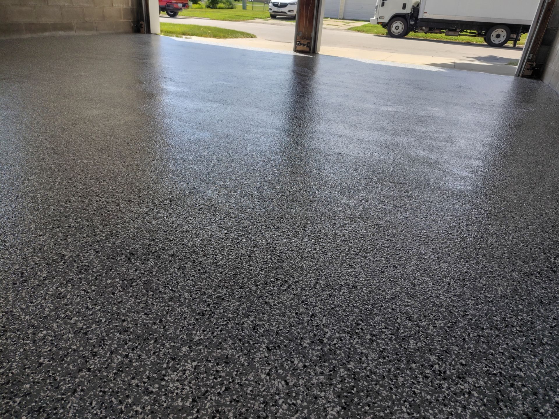 Wombat Flake Garage Floor Coating in Perry, IA by Revival Concrete Coatings