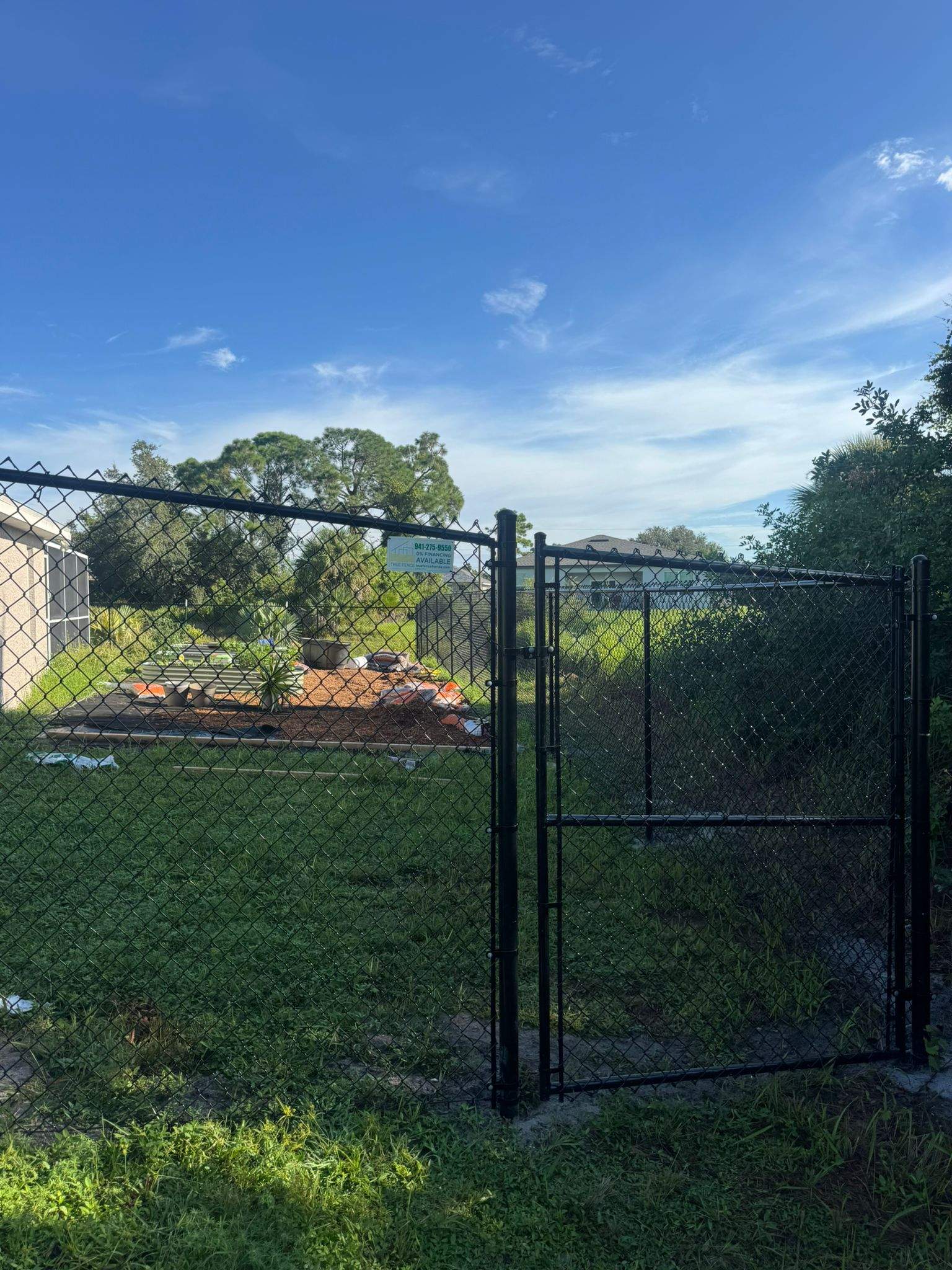 Black Vinyl-Coated Chain Link Fence and Gate Installation in North Port by True Fence LLC