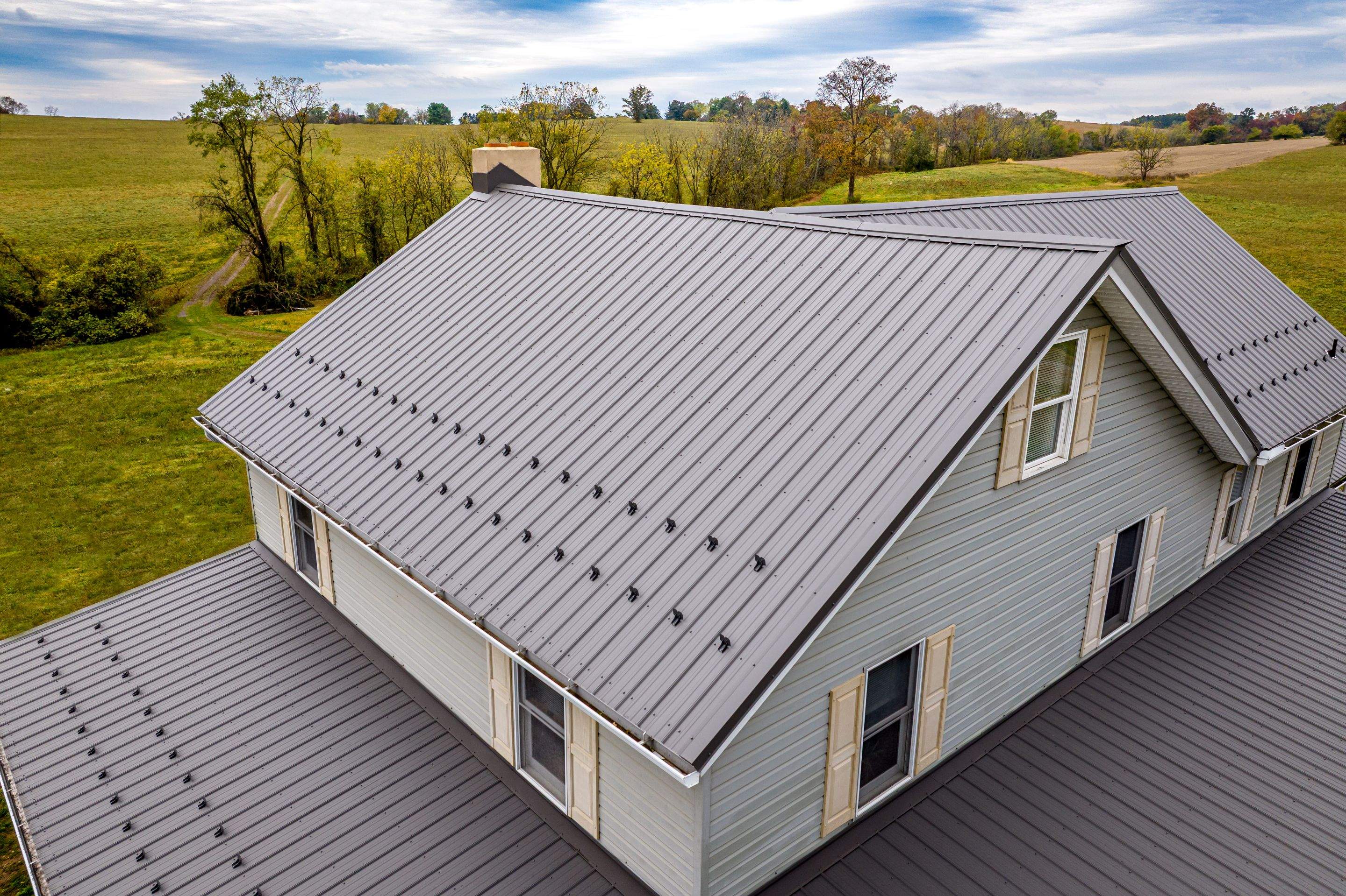 Classic Farmhouse With Textured Charcoal Metal Roof by Esh Builders