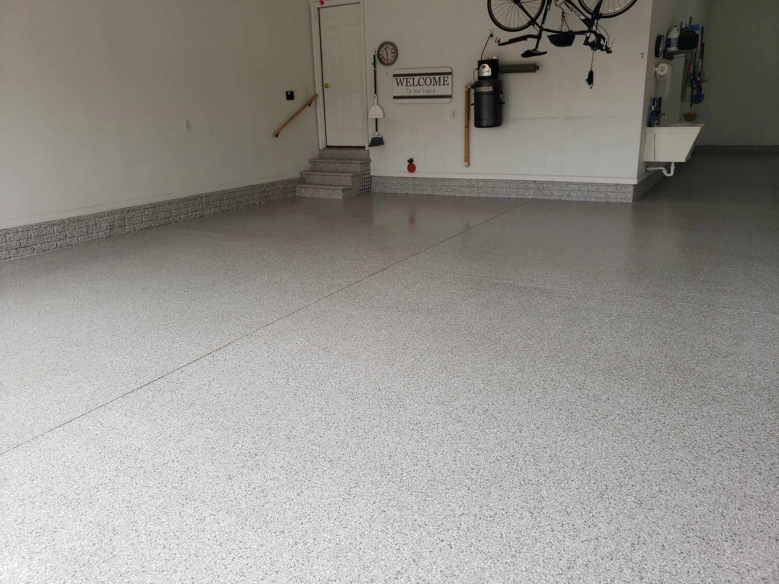 Des Moines Garage Transformation by Revival Concrete Coatings, LLC