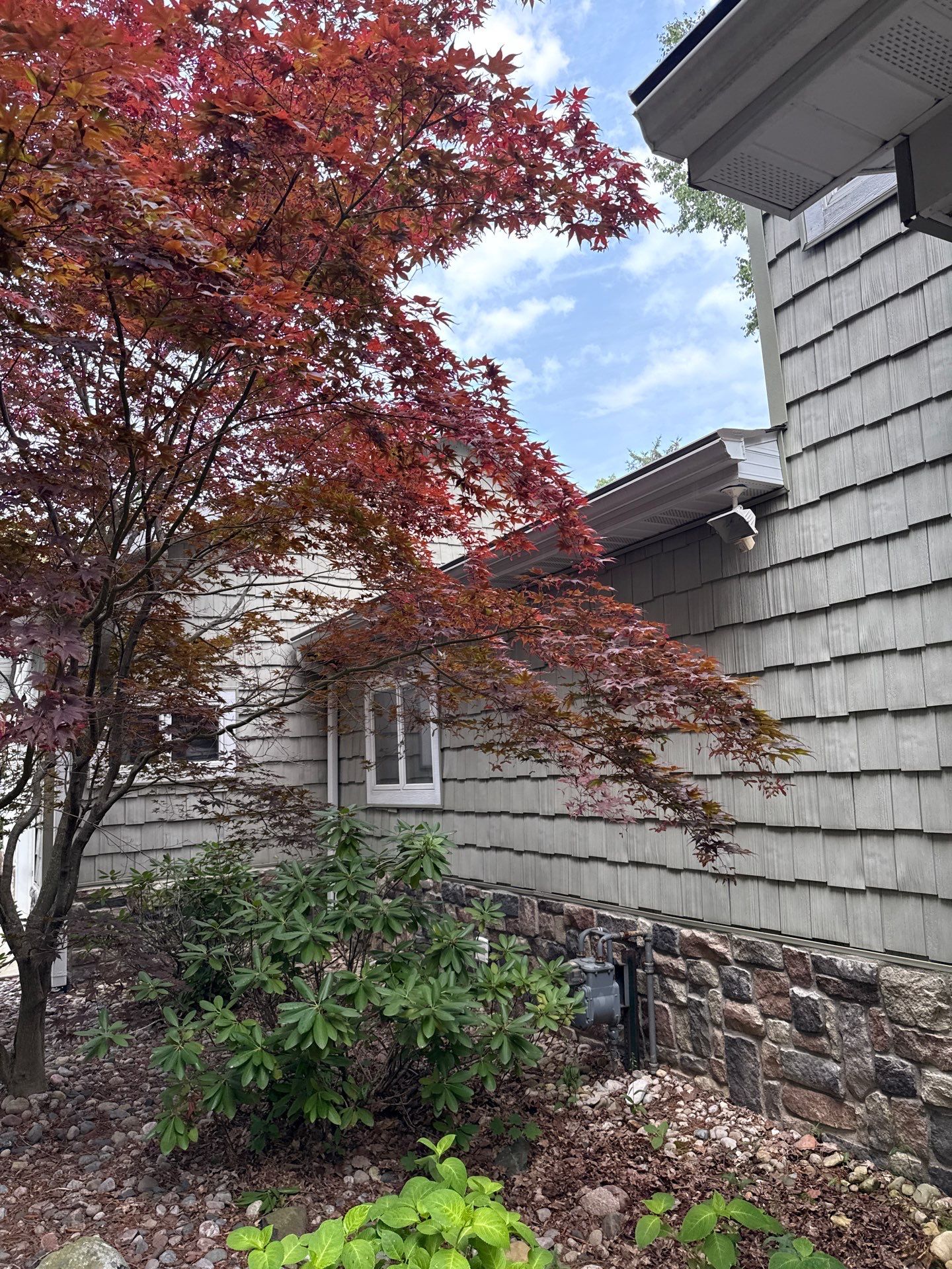 Gutter Helmet Protection System for Suttons Bay Home with Cedar Siding by Rainbow Seamless Systems