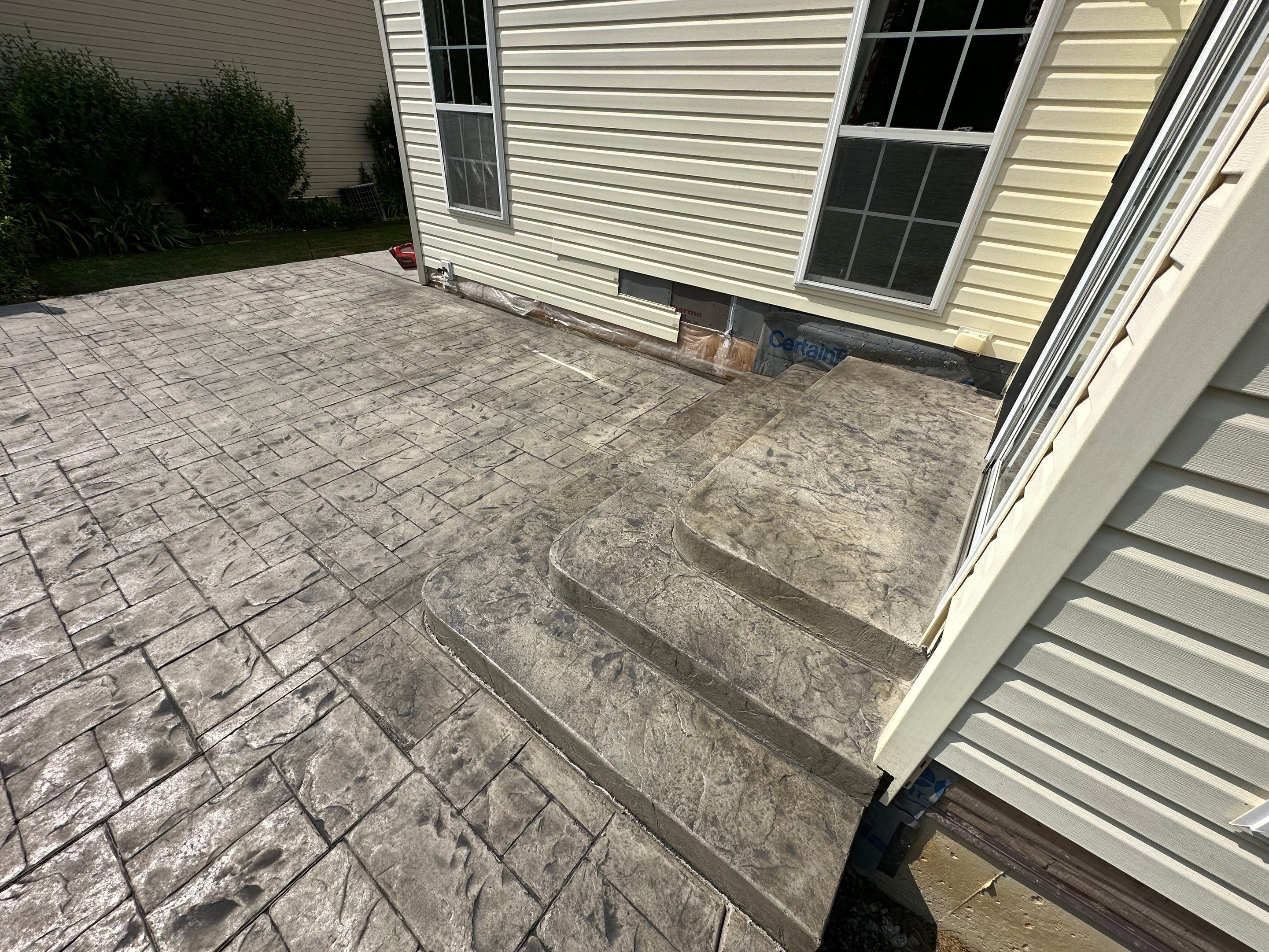 Stamped Concrete, Entry Door, and Concrete  by Ivy Lea Construction