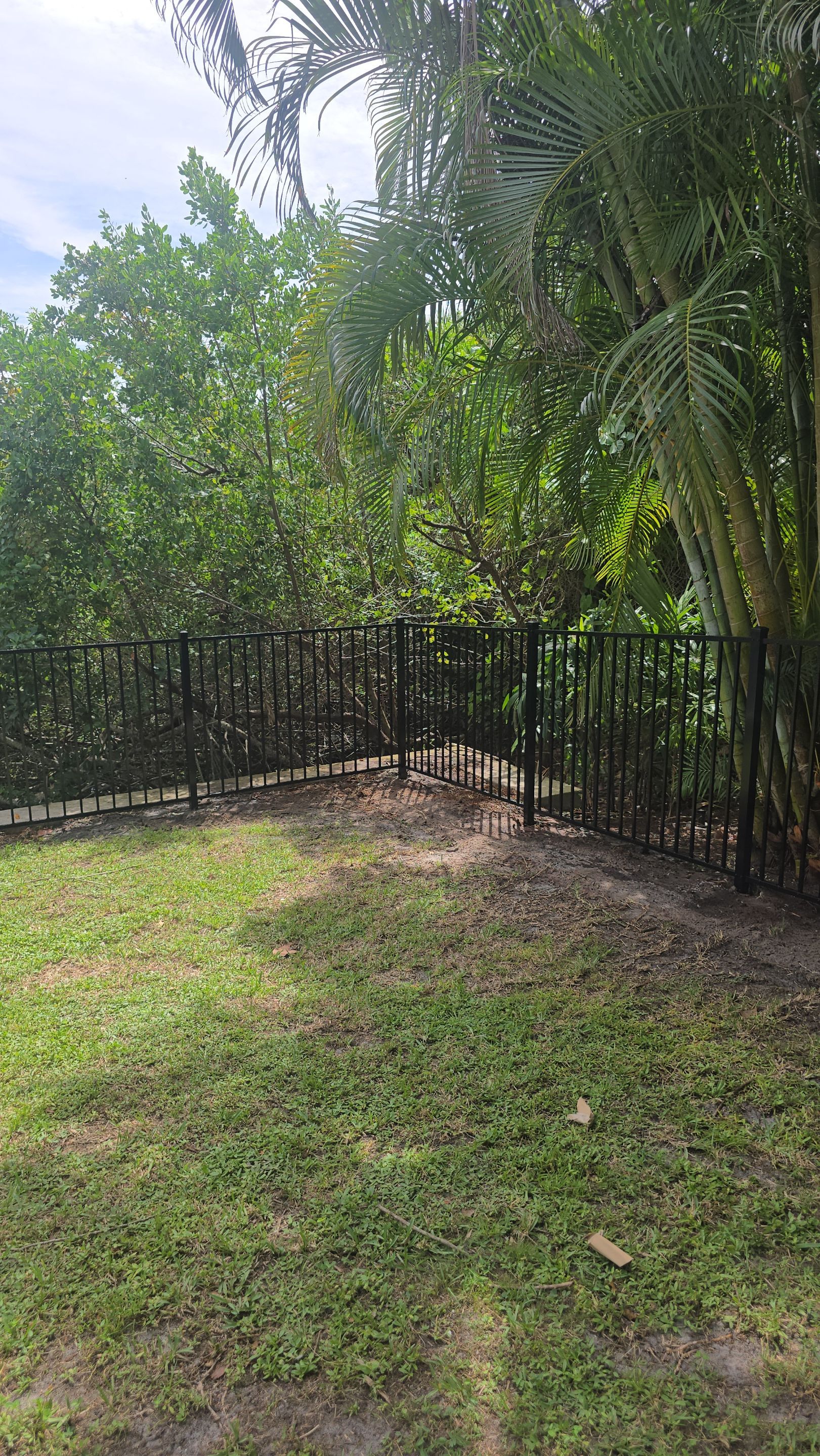 Black Aluminum Picket Fence Installation for Port Charlotte Canal Home by True Fence LLC