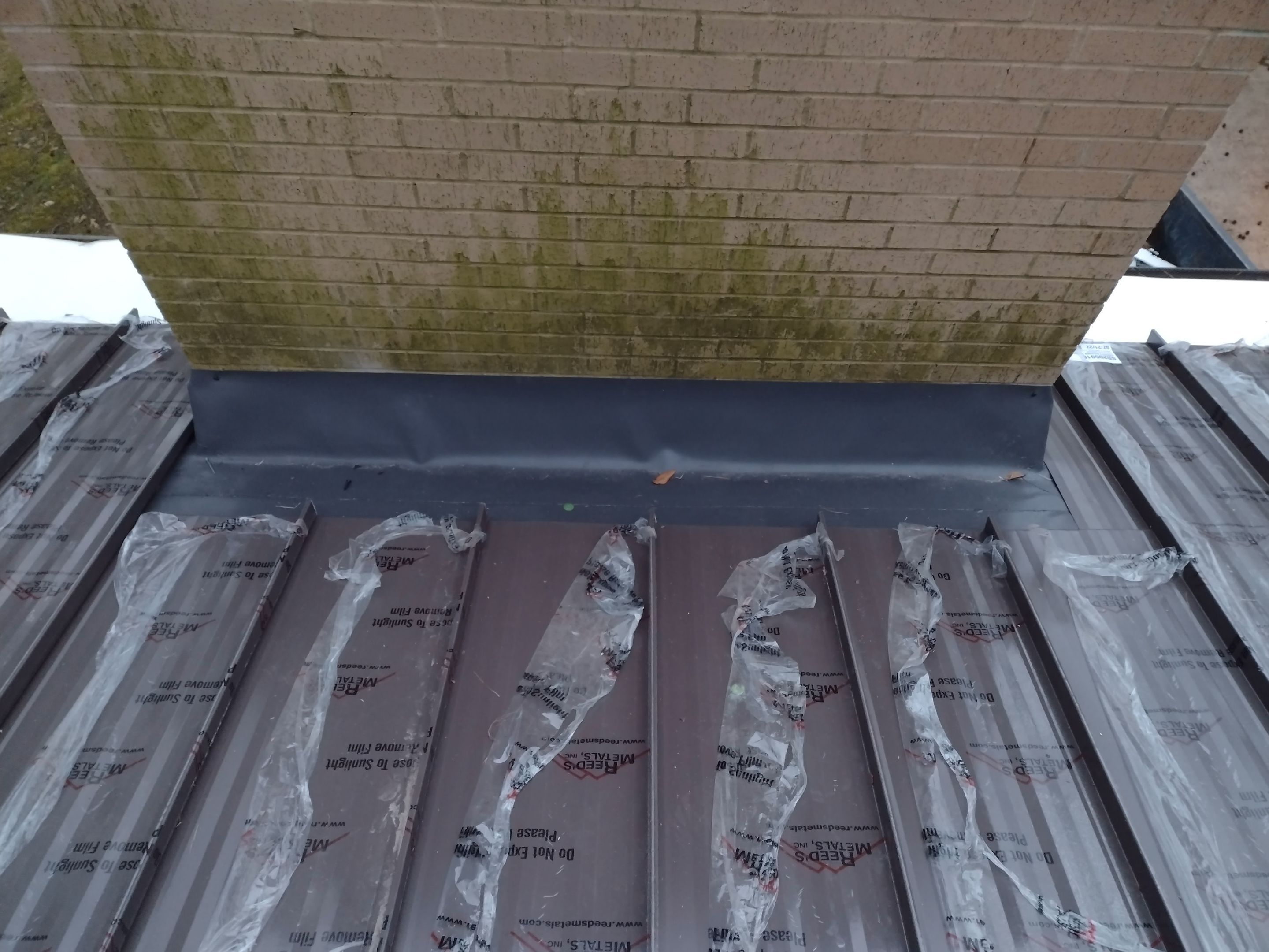Residential Roofing Installation using PVC membrane and 24 gauge Standing Seam Metal by Hostetler Roofing