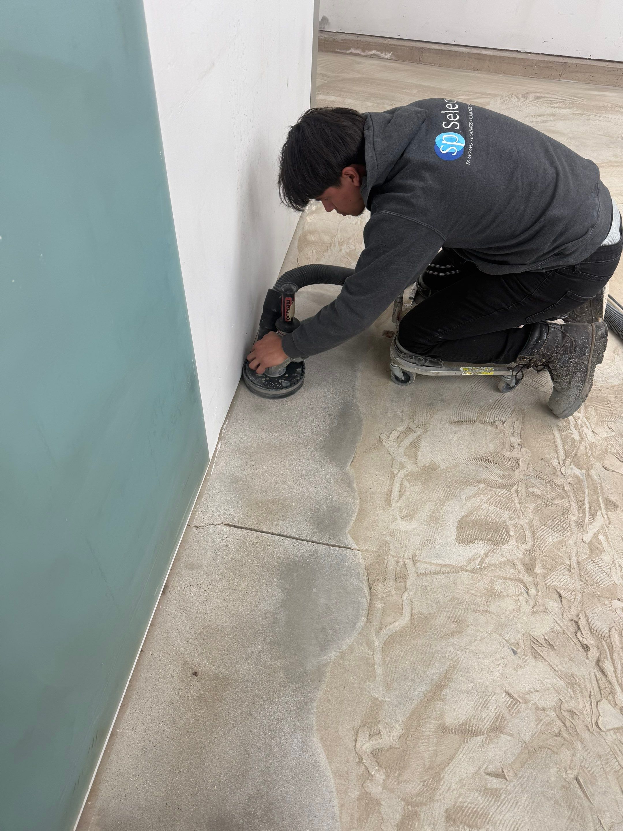 Feather Gray Epoxy Floor Coating Installation in Sioux Falls by Select Painting, Coatings & Garage Cabinets