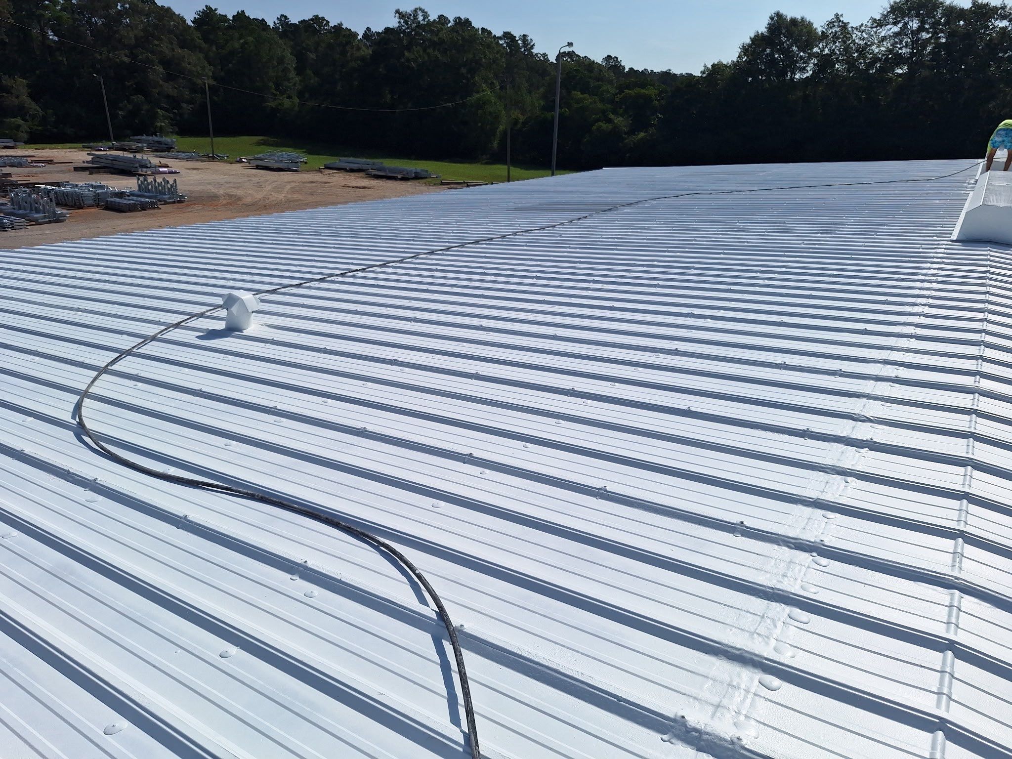 Commercial Metal Roof Restoration with White Protective Coating by Southern Roof Solutions