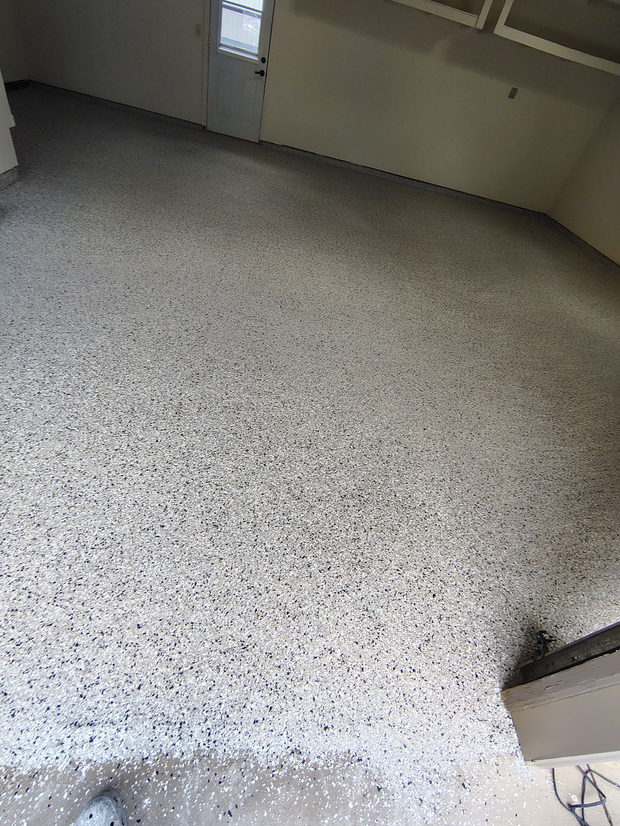 Full-Flake Epoxy Garage Floor Coating Installation in Sioux Falls by Select Painting, Coatings & Garage Cabinets