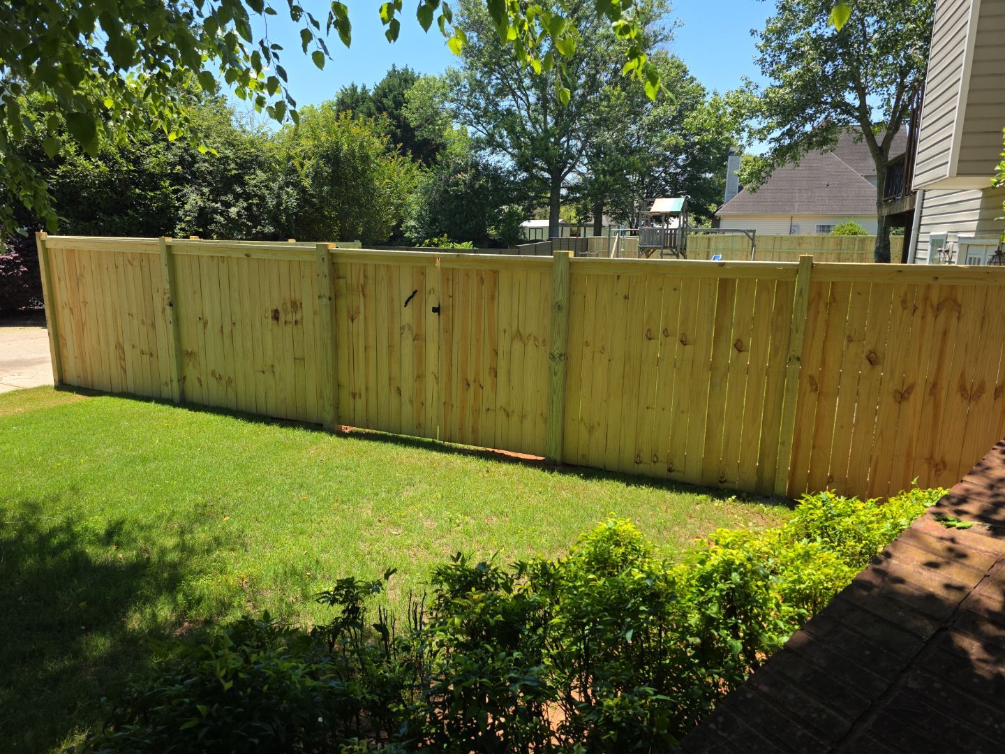 Fence Installation of a Capped Wood Privacy Fence by Titans of Timber Fence & Stain