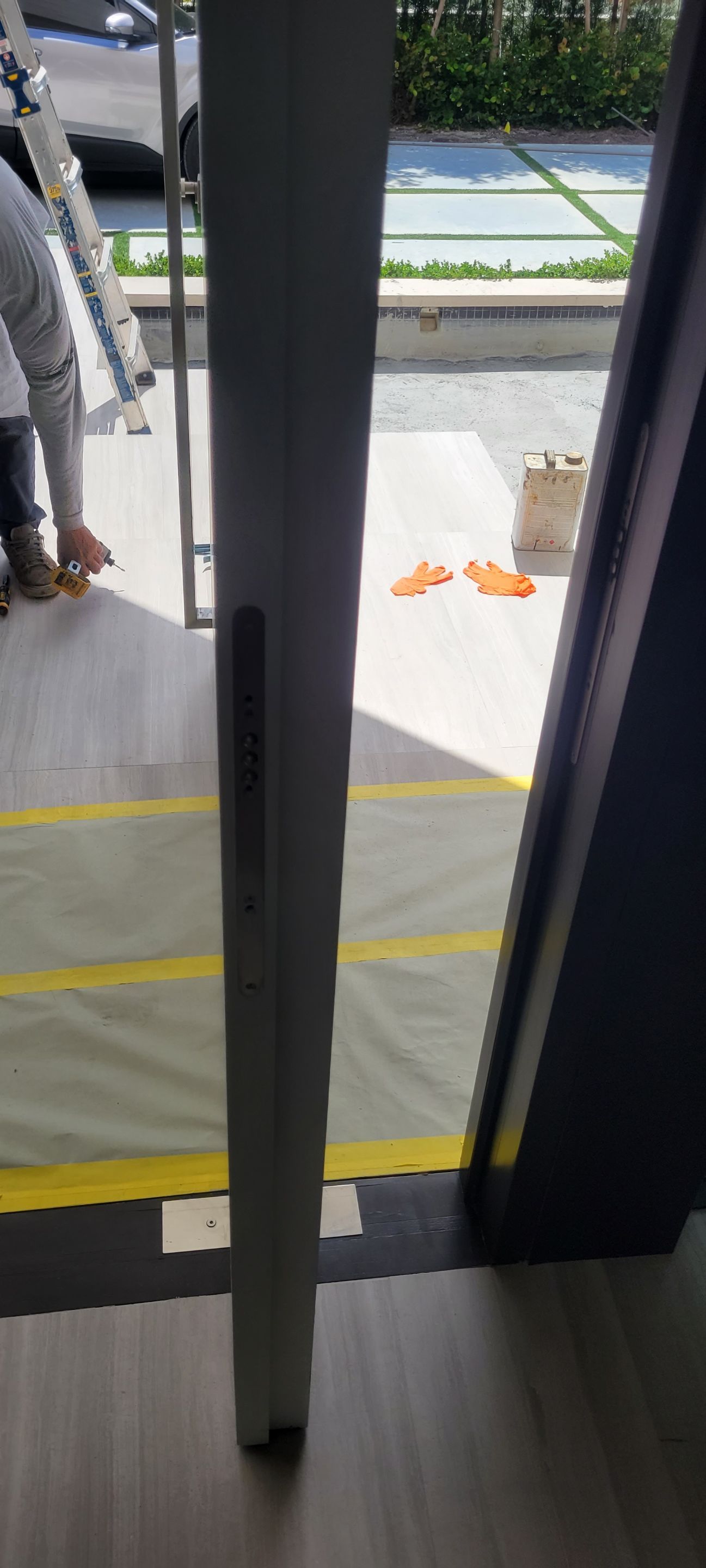 Custom Material Pivot Door installation by Impact Precious Wood Inc.