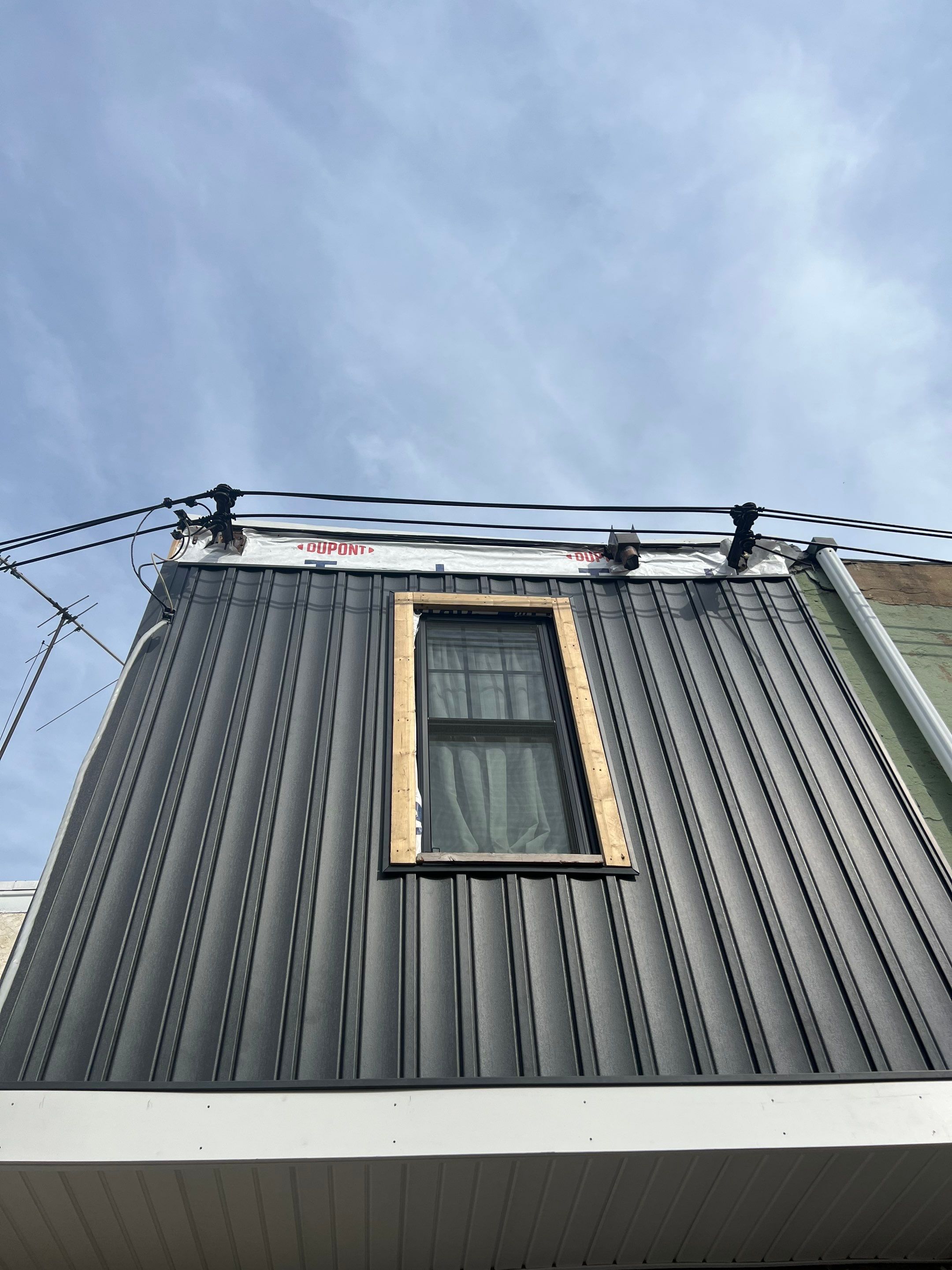 Vertical Black Metal Siding Installation for Philadelphia Home Exterior by Hybrid Roofing And Renovations